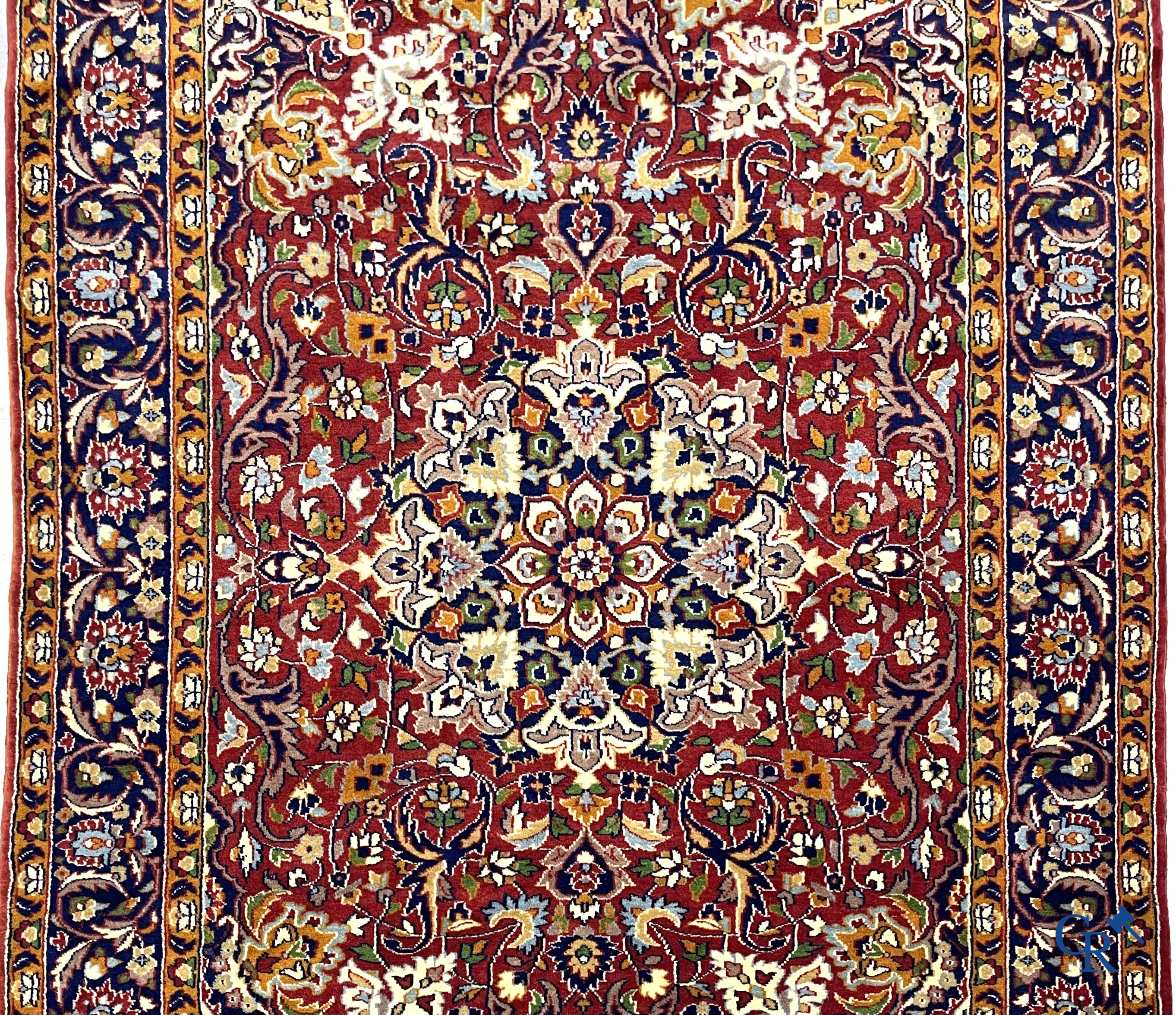 Oriental carpets. Finely hand-knotted carpet with floral decor on a dark red background.