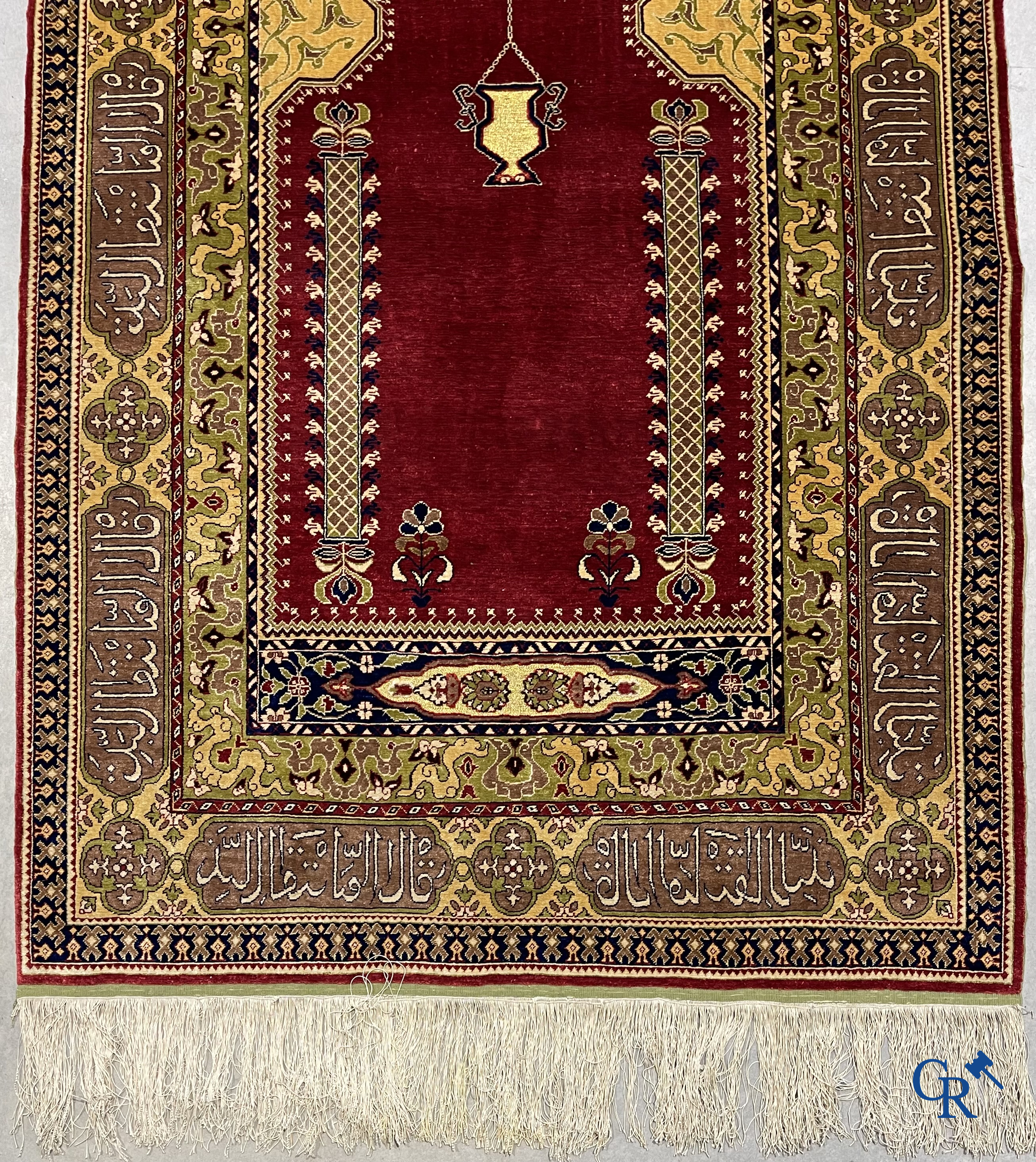 Oosterse tapijten. Een uiterst fijn handgeknoopt zijden tapijt met inscripties en gouddraad. Gesigneerd.