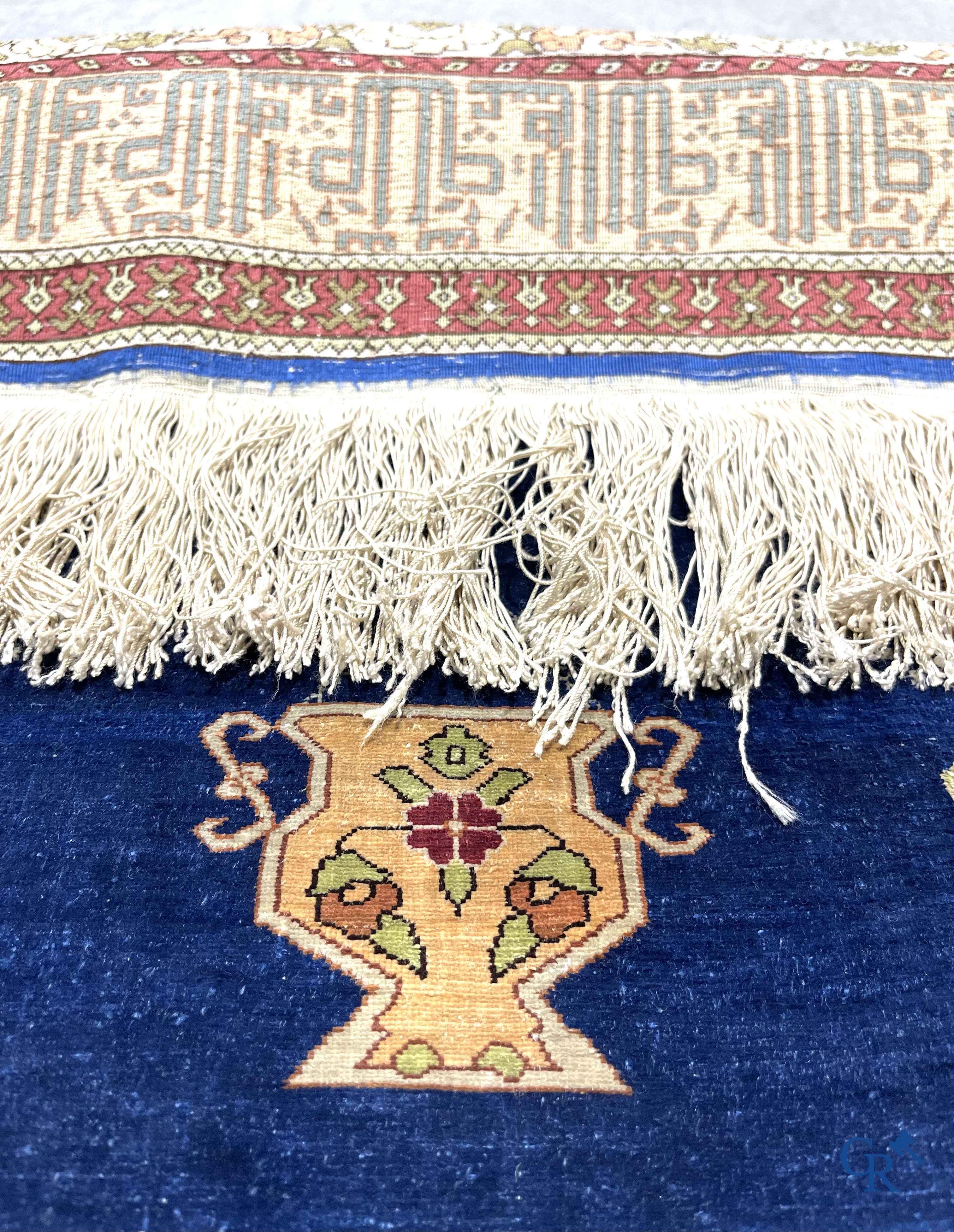 Oriental carpets. Extremely finely hand knotted silk carpet with inscriptions and gold thread. Signed.