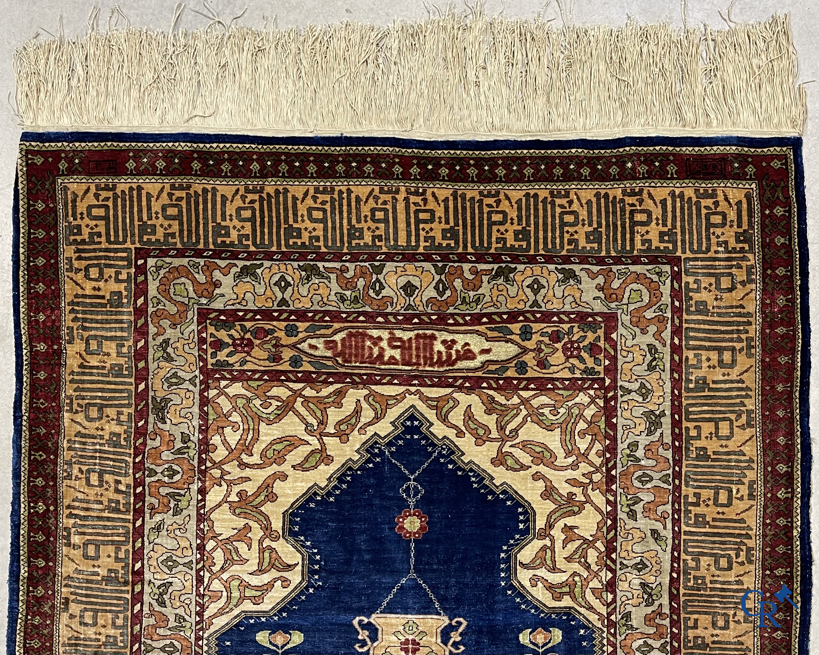 Oriental carpets. Extremely finely hand knotted silk carpet with inscriptions and gold thread. Signed.