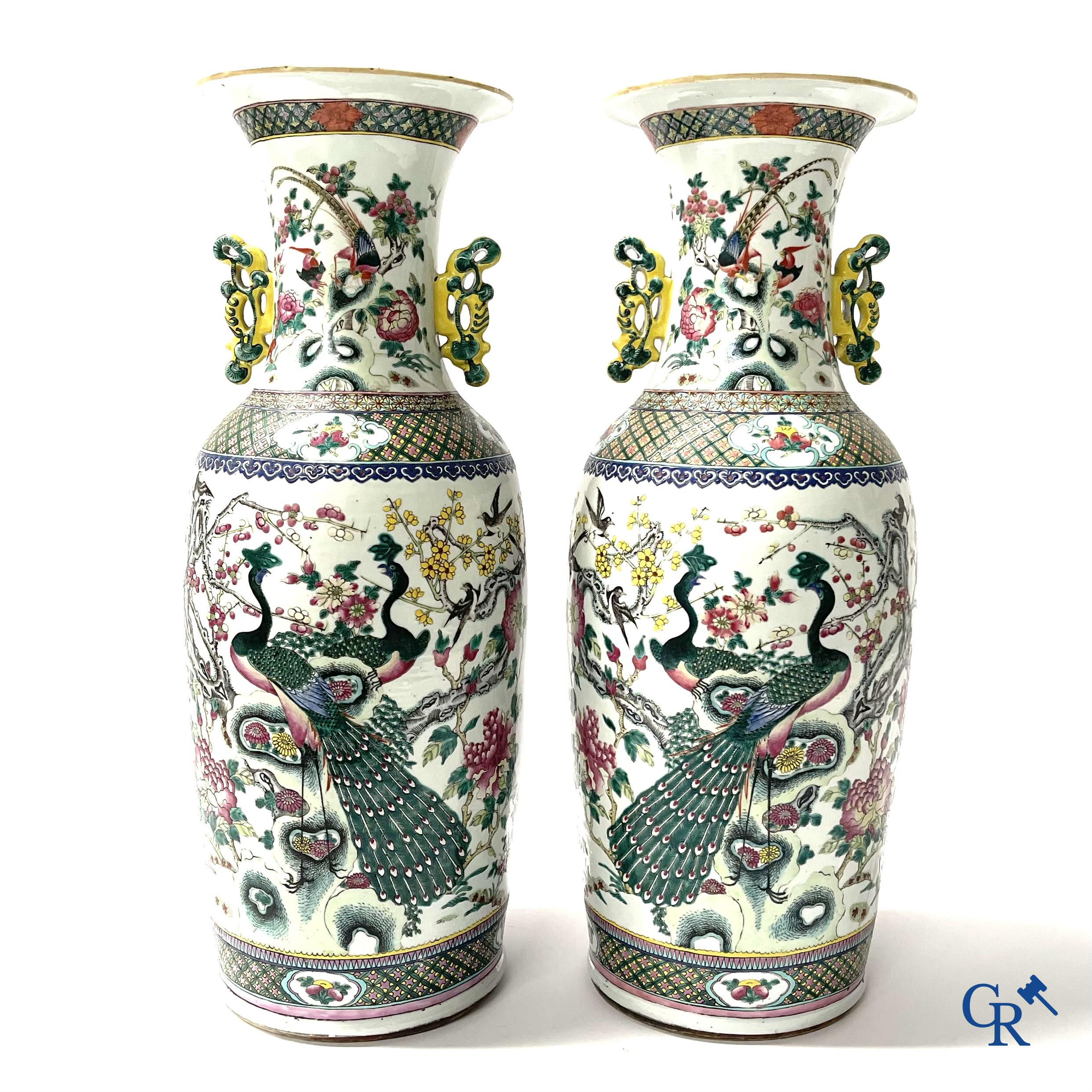 Asian Art, A pair of Chinese famille rose vases with peacocks and Fo dogs. 19th century.