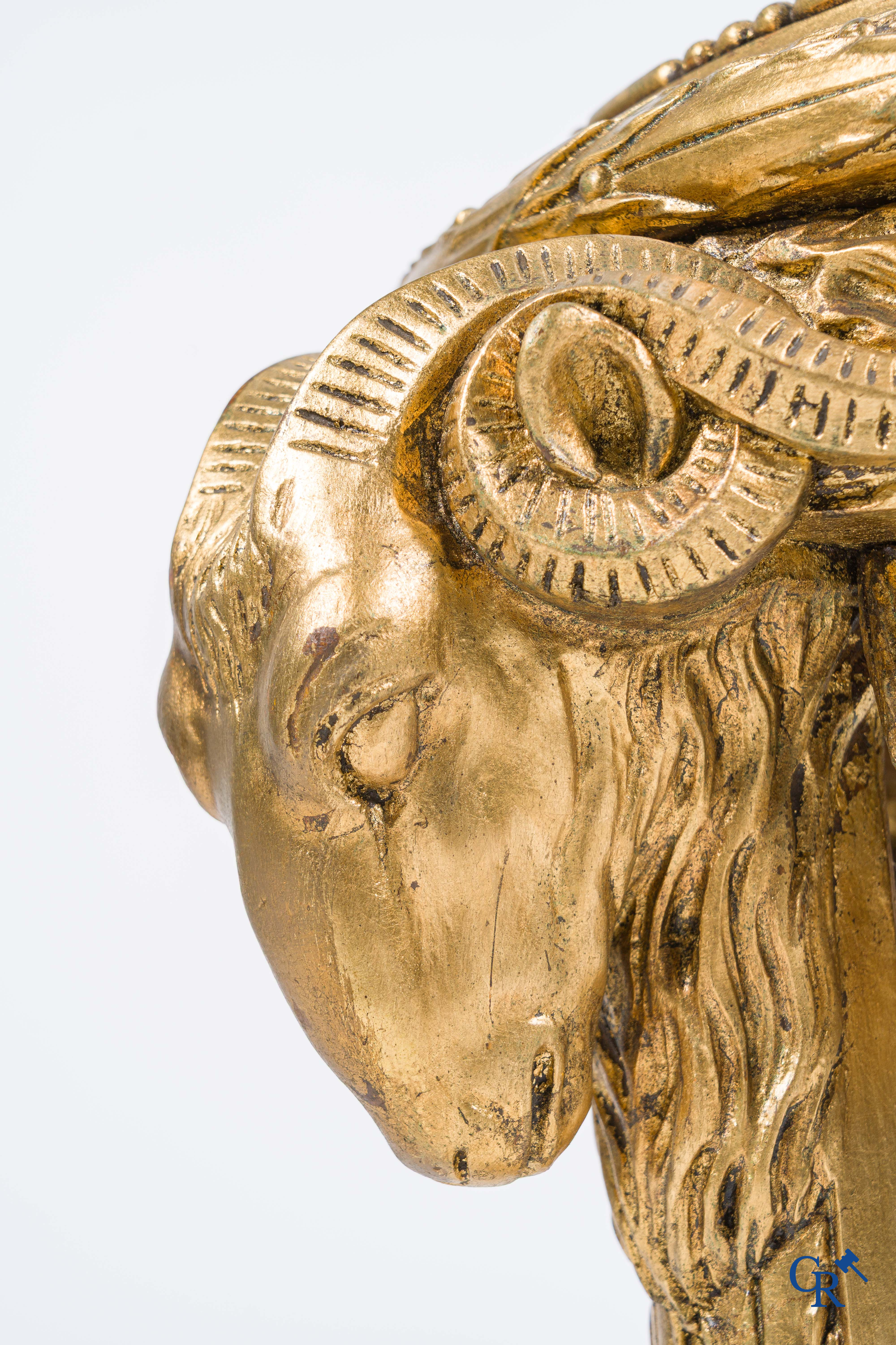 A large wood carved and gilded plinth with ram heads and garlands. LXVI style, circa 1900.