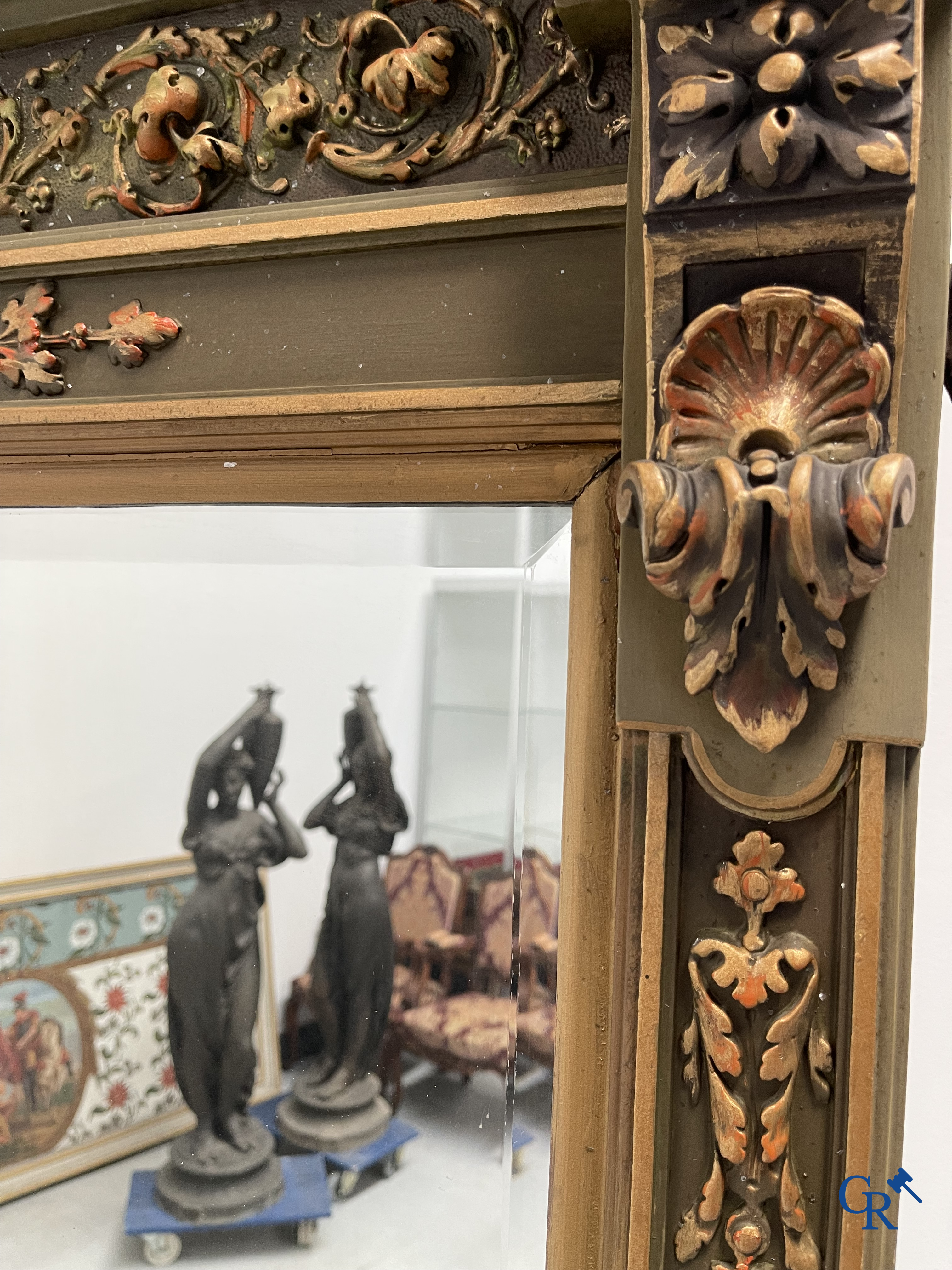 A large patinated fireplace mirror with a dragon. Around 1900.