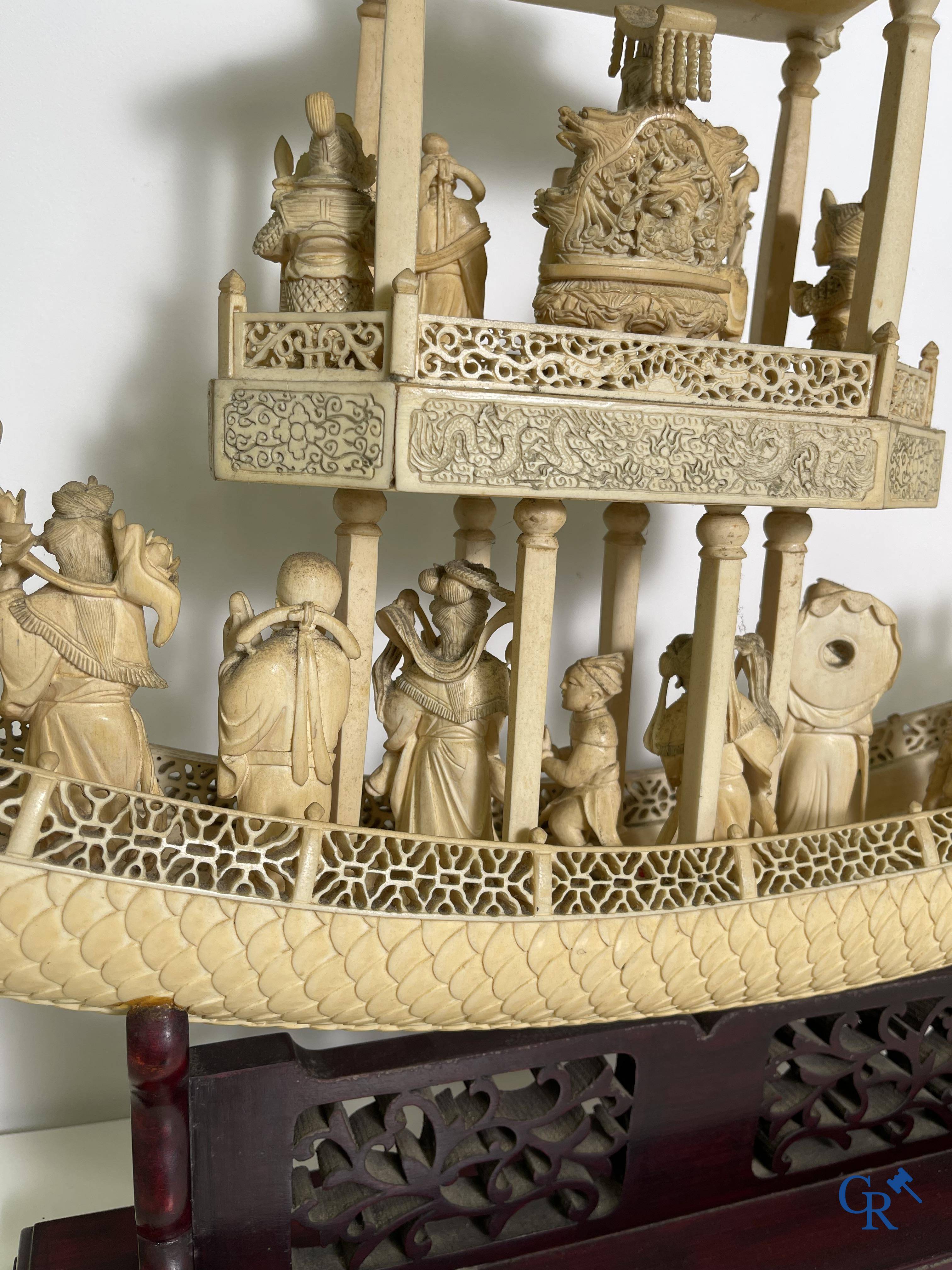 Asian Art: A large Chinese ivory dragon boat on a wooden pedestal. 19th century.