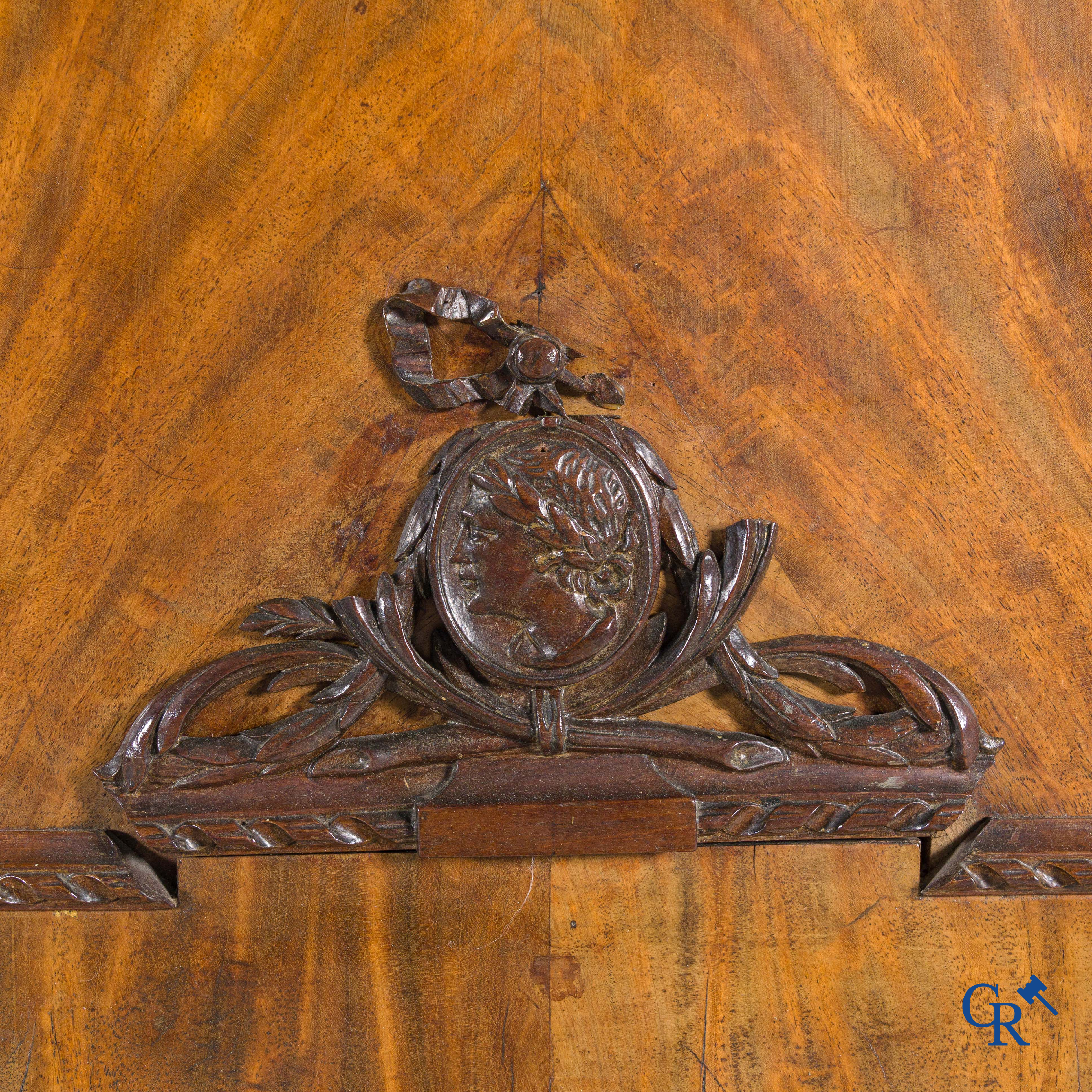 A large mahogany wooden cabinet with 3 drawers and 2 doors decorated with lockets. LXVI style.