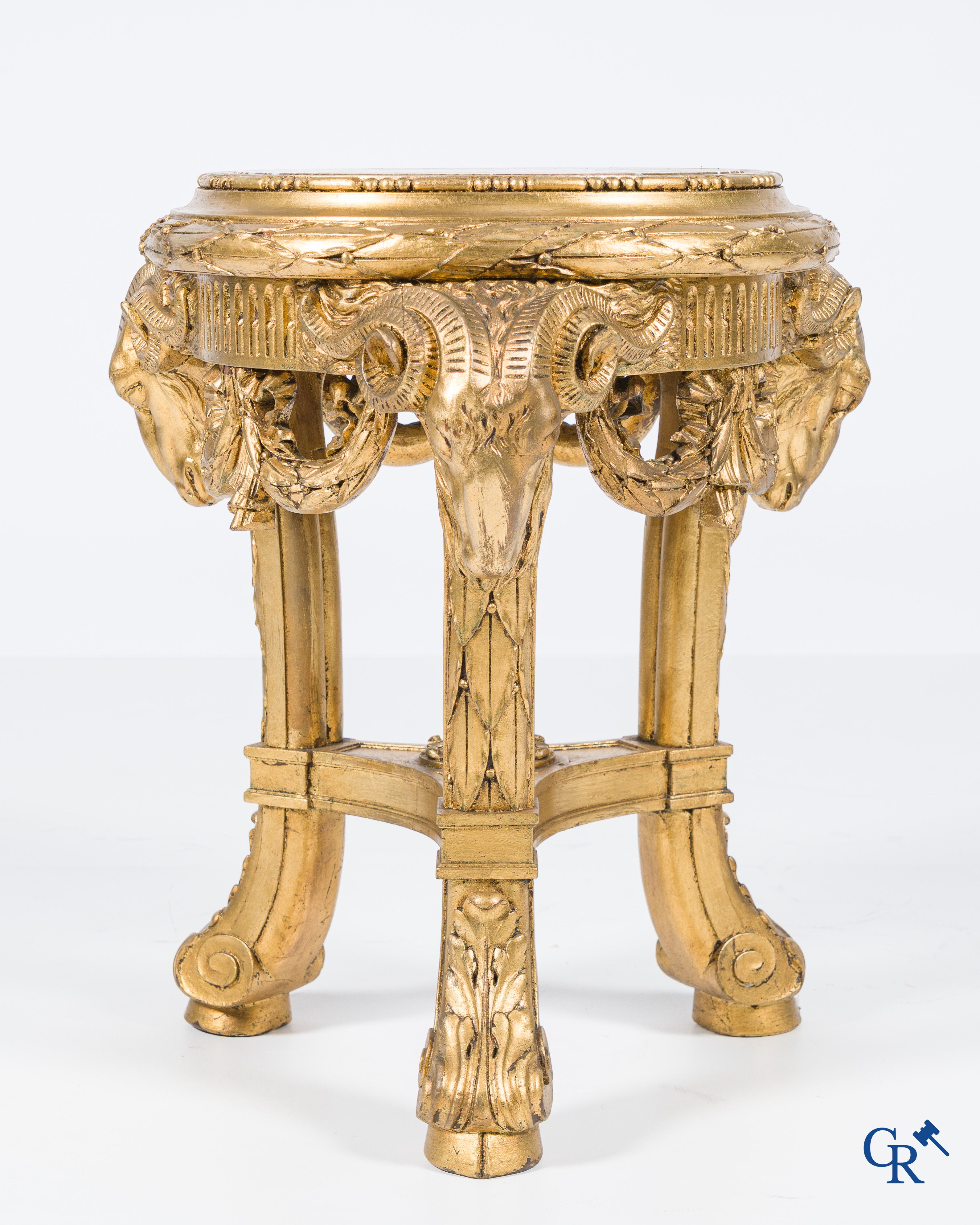 A large wood carved and gilded plinth with ram heads and garlands. LXVI style, circa 1900.