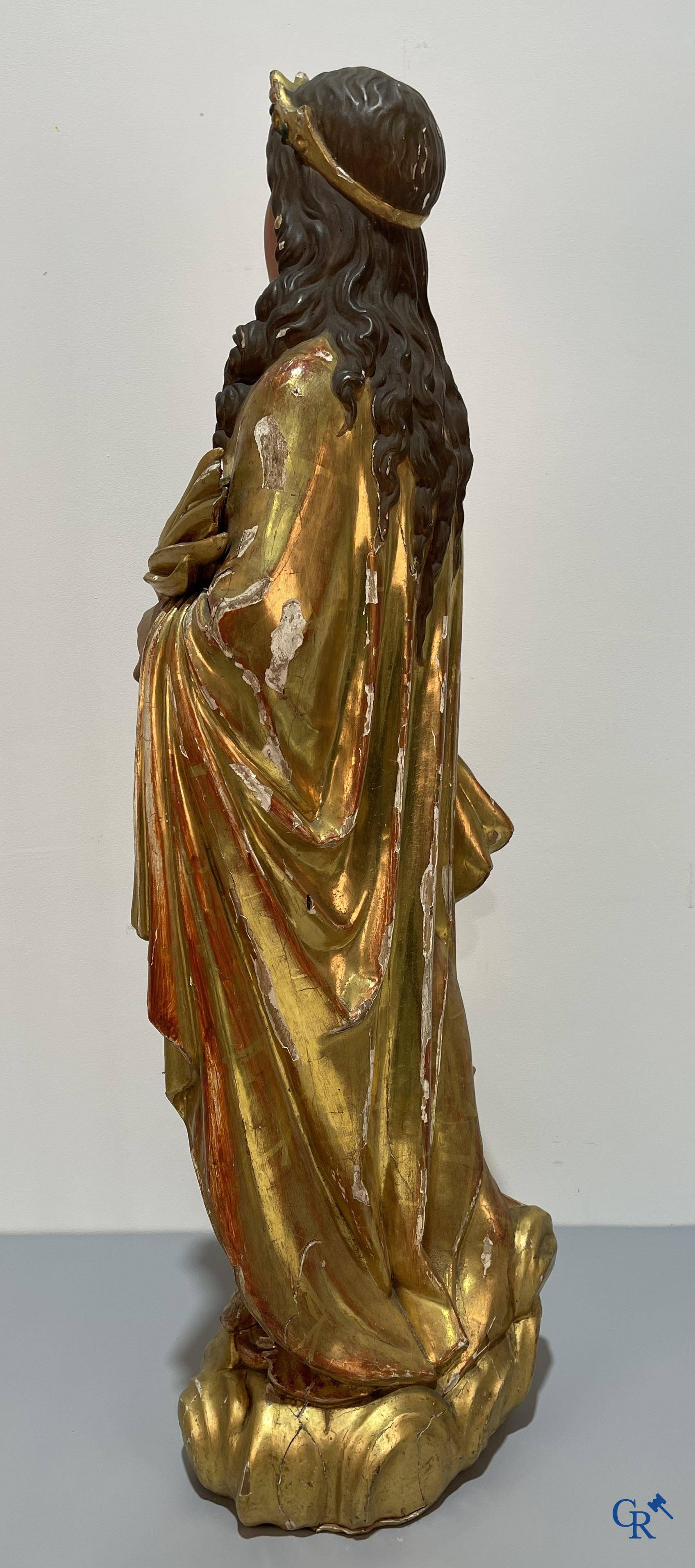 A large gilded and polychrome wooden statue of Saint Catherine of Alexandria.