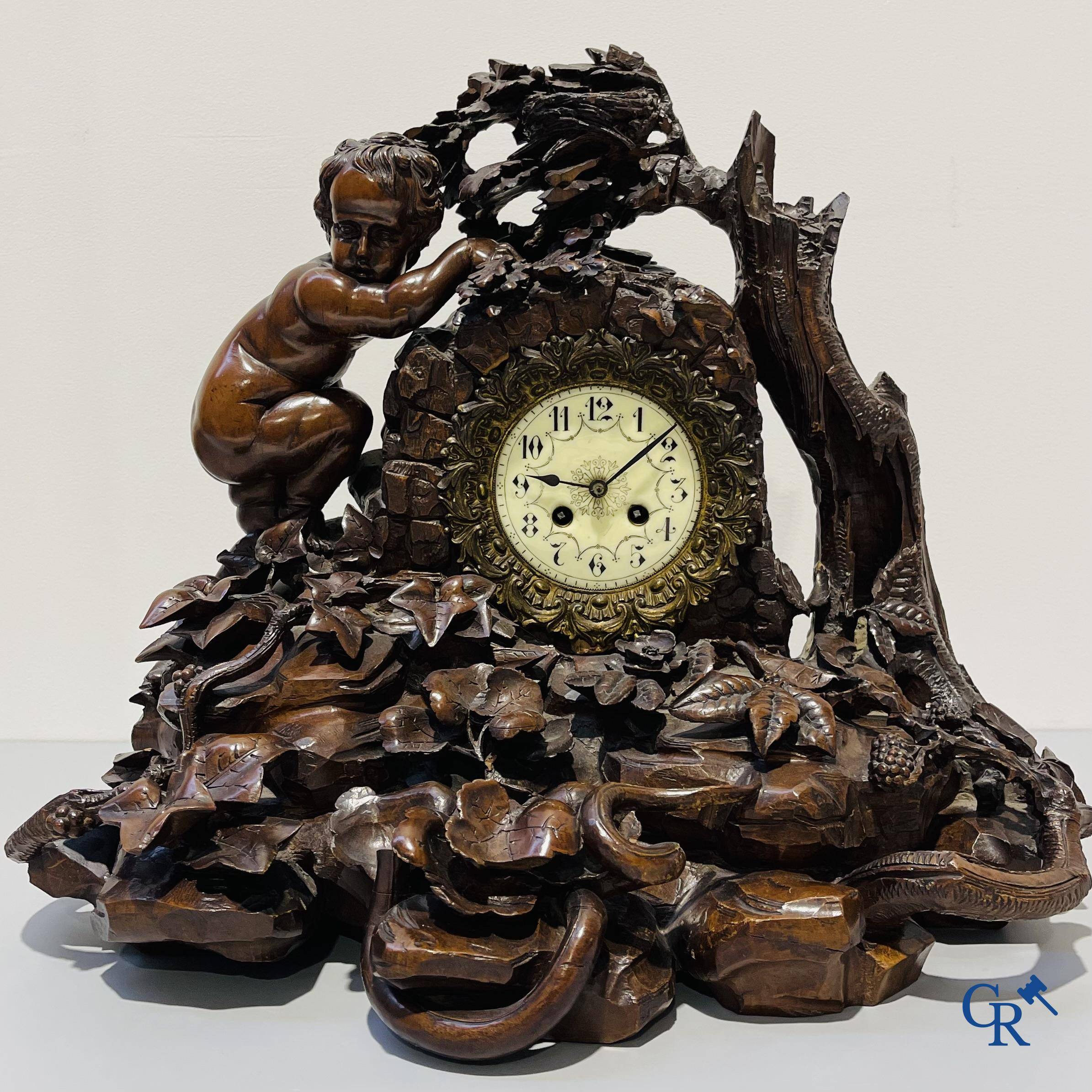 A finely carved walnut clock in so-called "black forest" carving. French work circa 1860-1880.