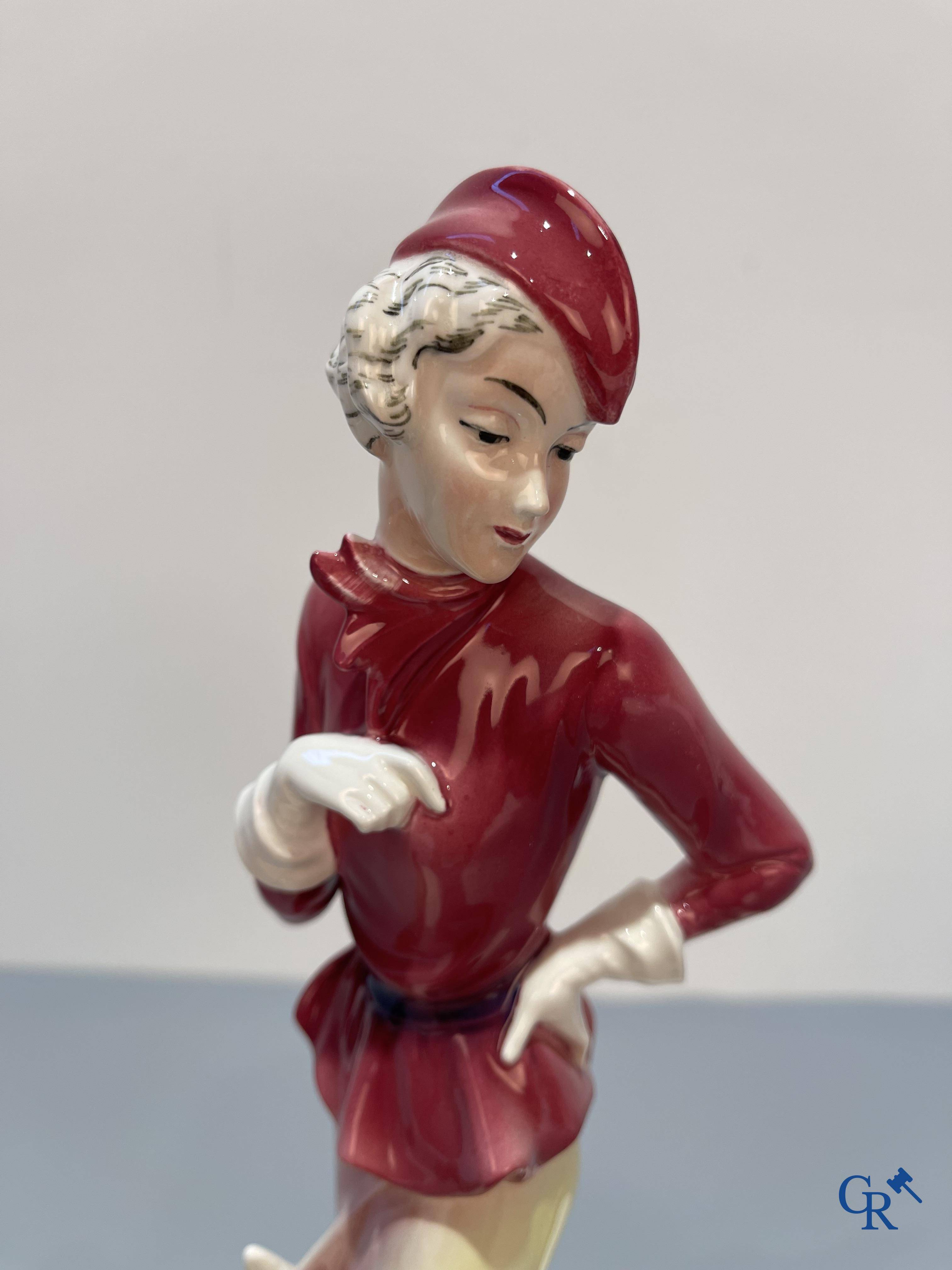 European porcelain, Katzhutte Hertwig, an Art Deco statue of a lady with dogs. Marked and numbered 74.