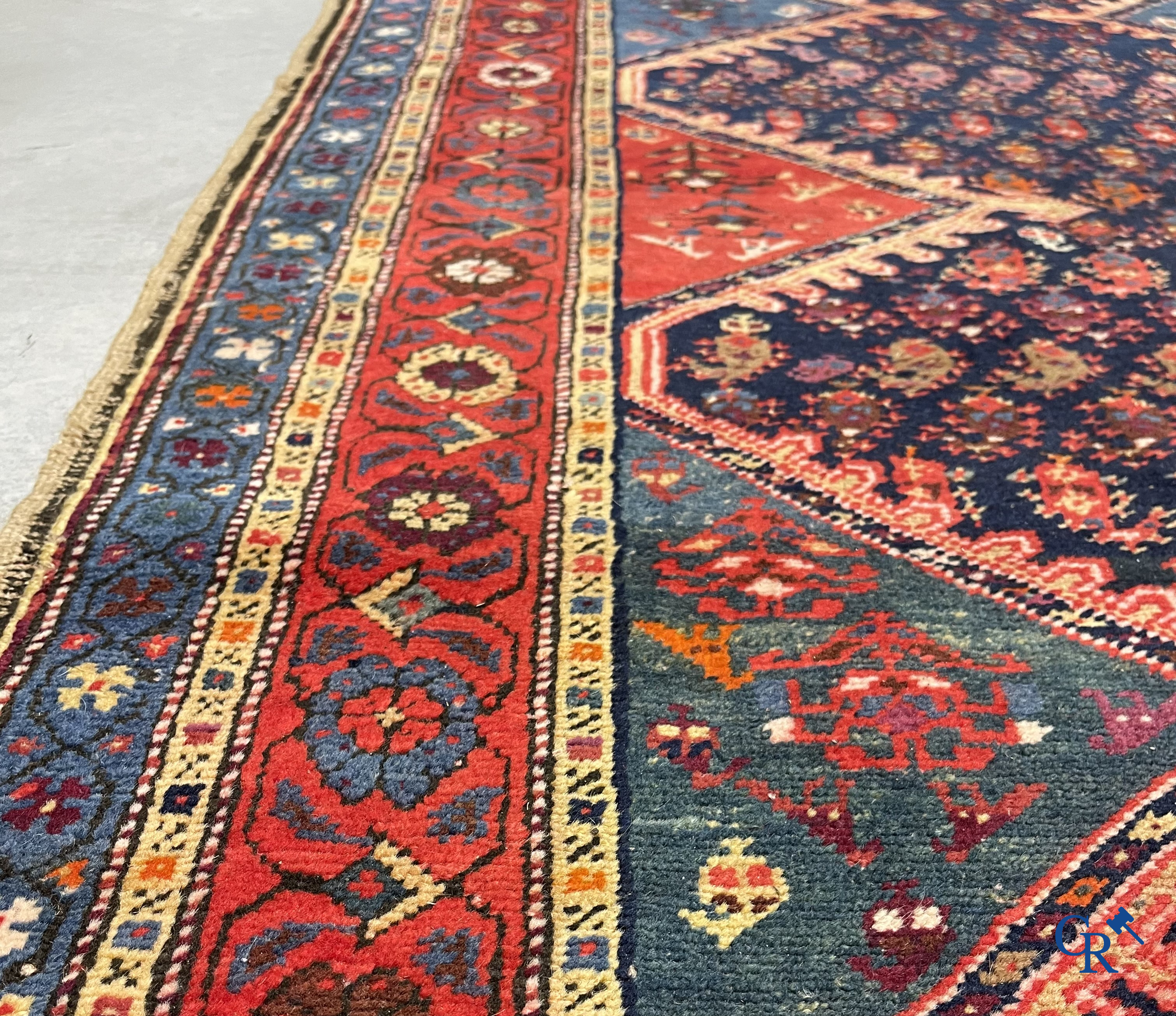 Oriental carpets. A large hand-knotted antique runner with geometric motifs. 19th century.