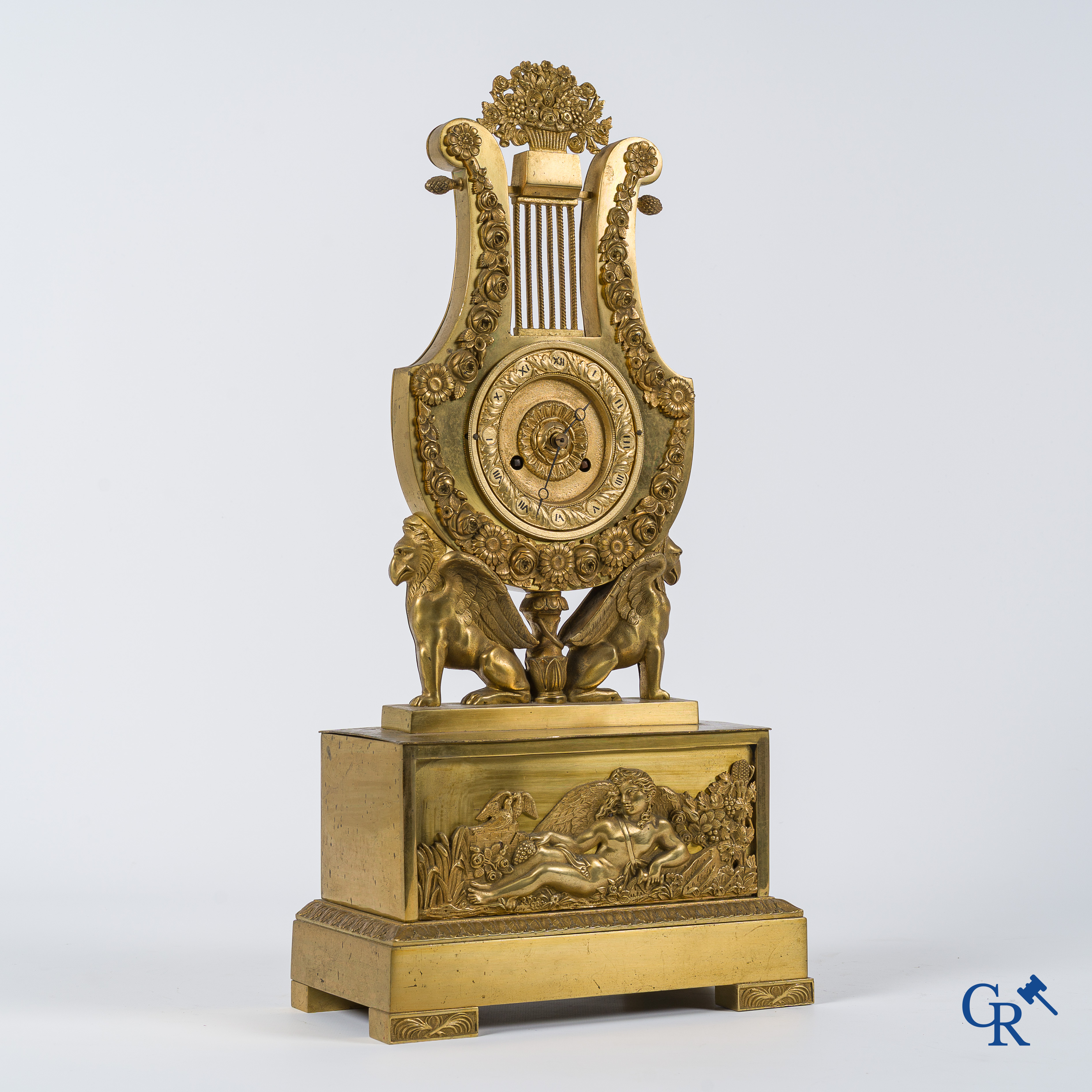 Charles X period. Beautiful pendulum in gilded bronze, a lyre held up by griffins. France, circa 1825.