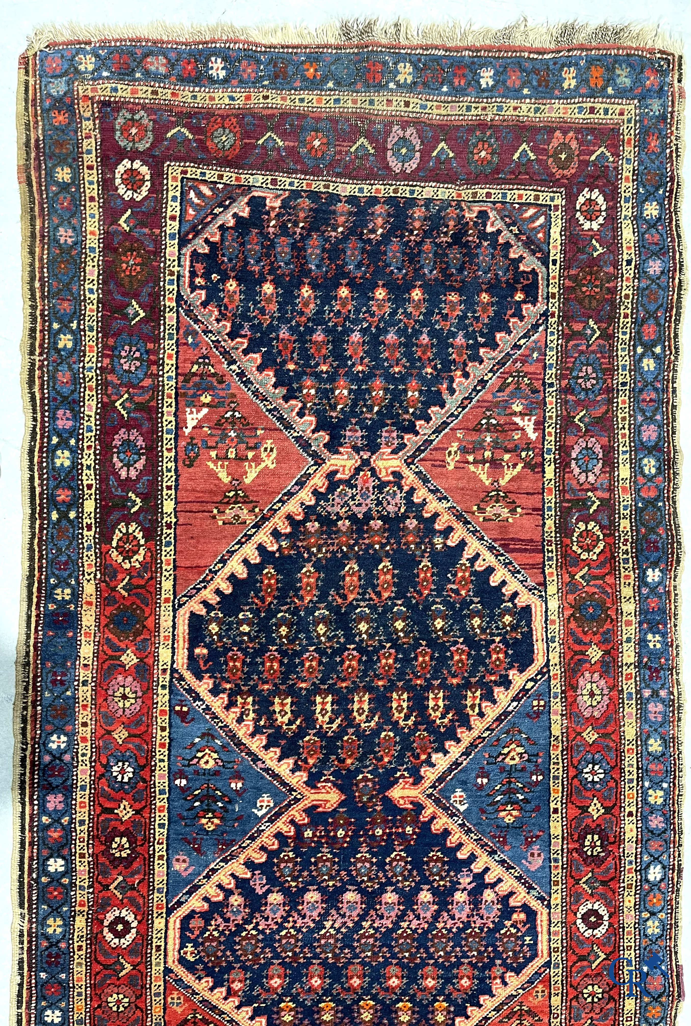 Oriental carpets. A large hand-knotted antique runner with geometric motifs. 19th century.