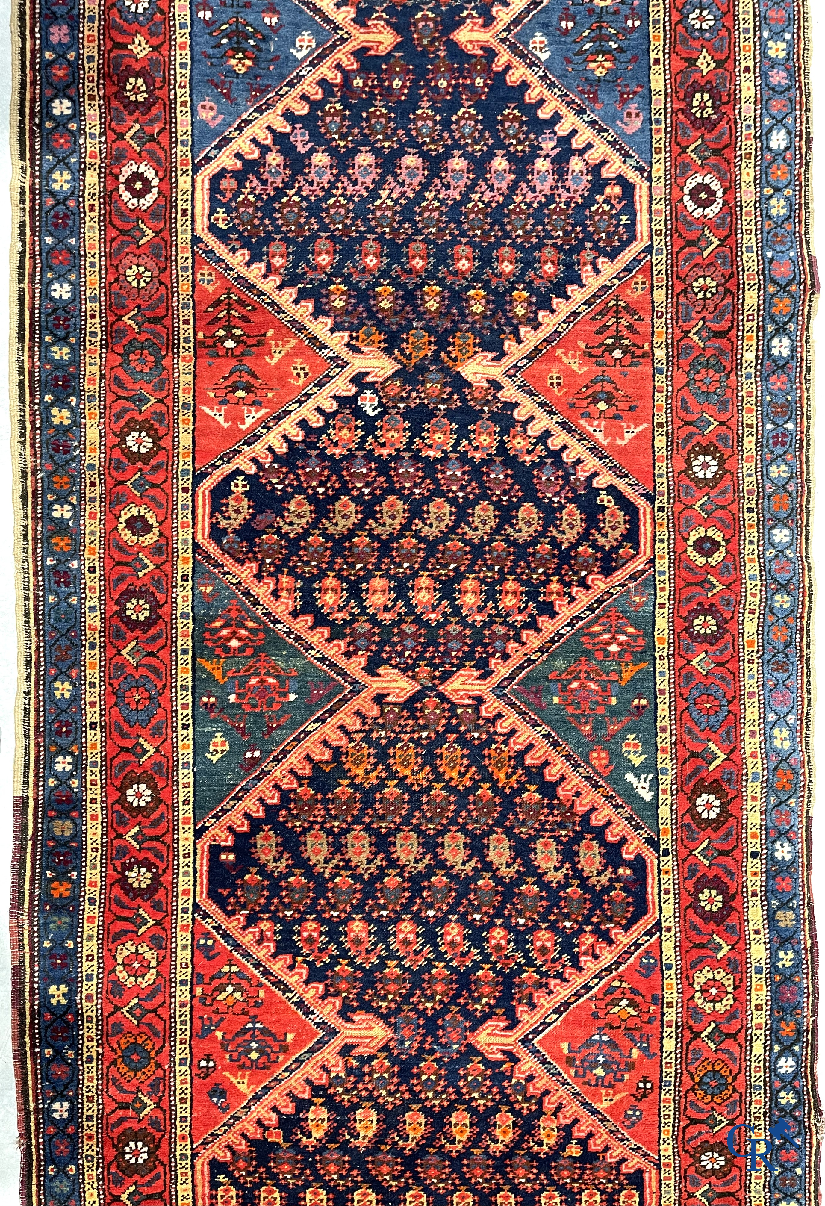 Oriental carpets. A large hand-knotted antique runner with geometric motifs. 19th century.