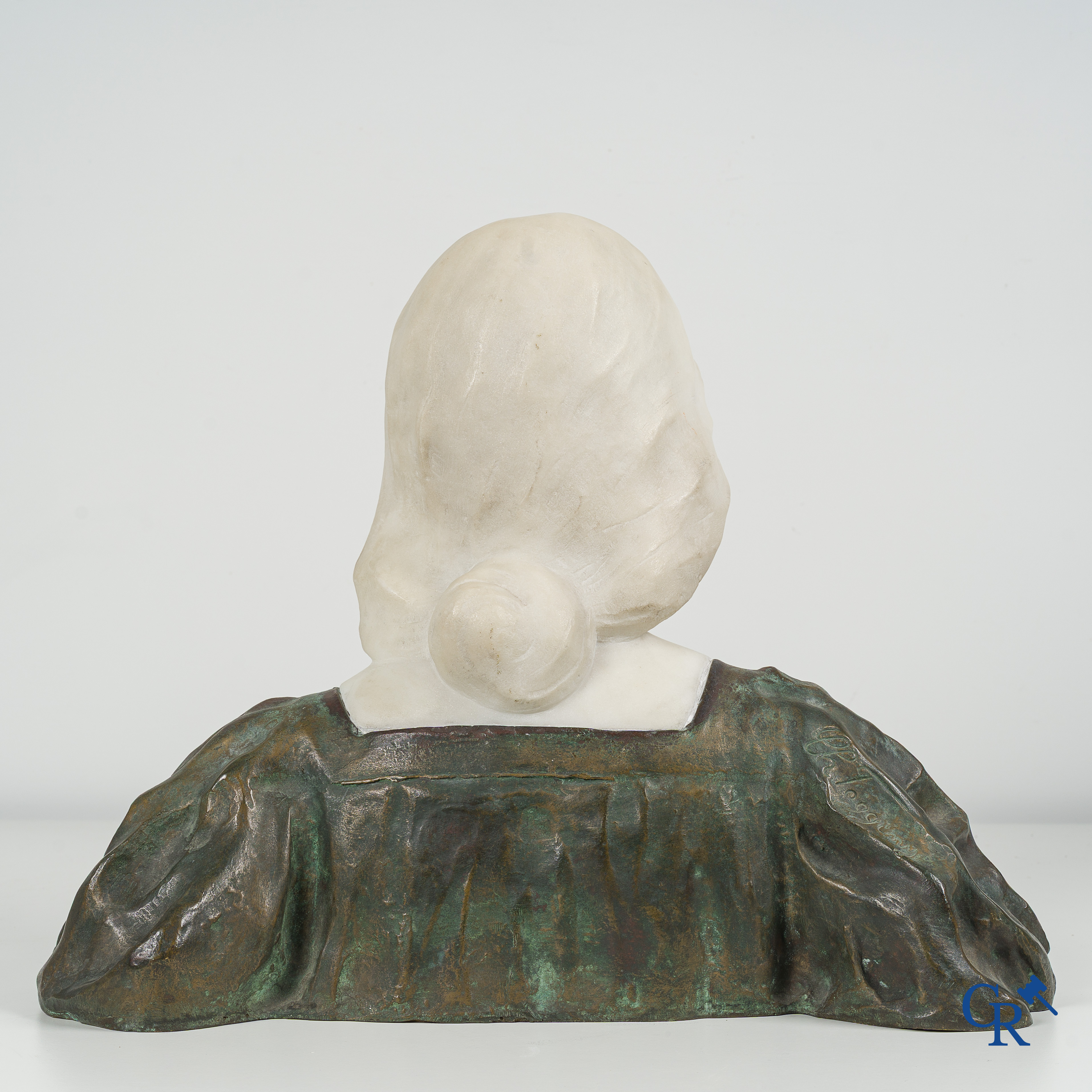 Art Nouveau. Bust of a young lady in Carrara marble and brown-green patinated bronze. Signed, circa 1900.