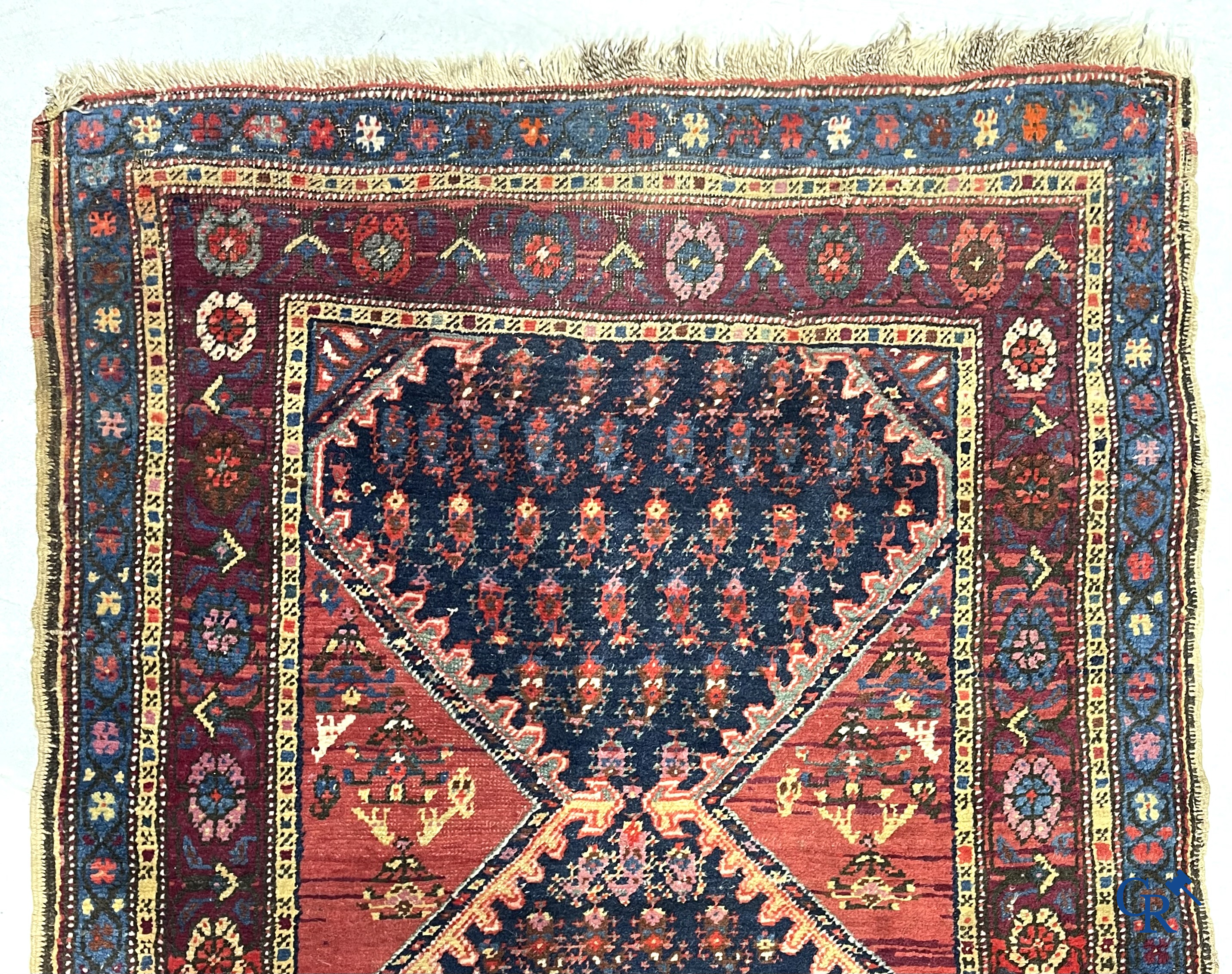 Oriental carpets. A large hand-knotted antique runner with geometric motifs. 19th century.