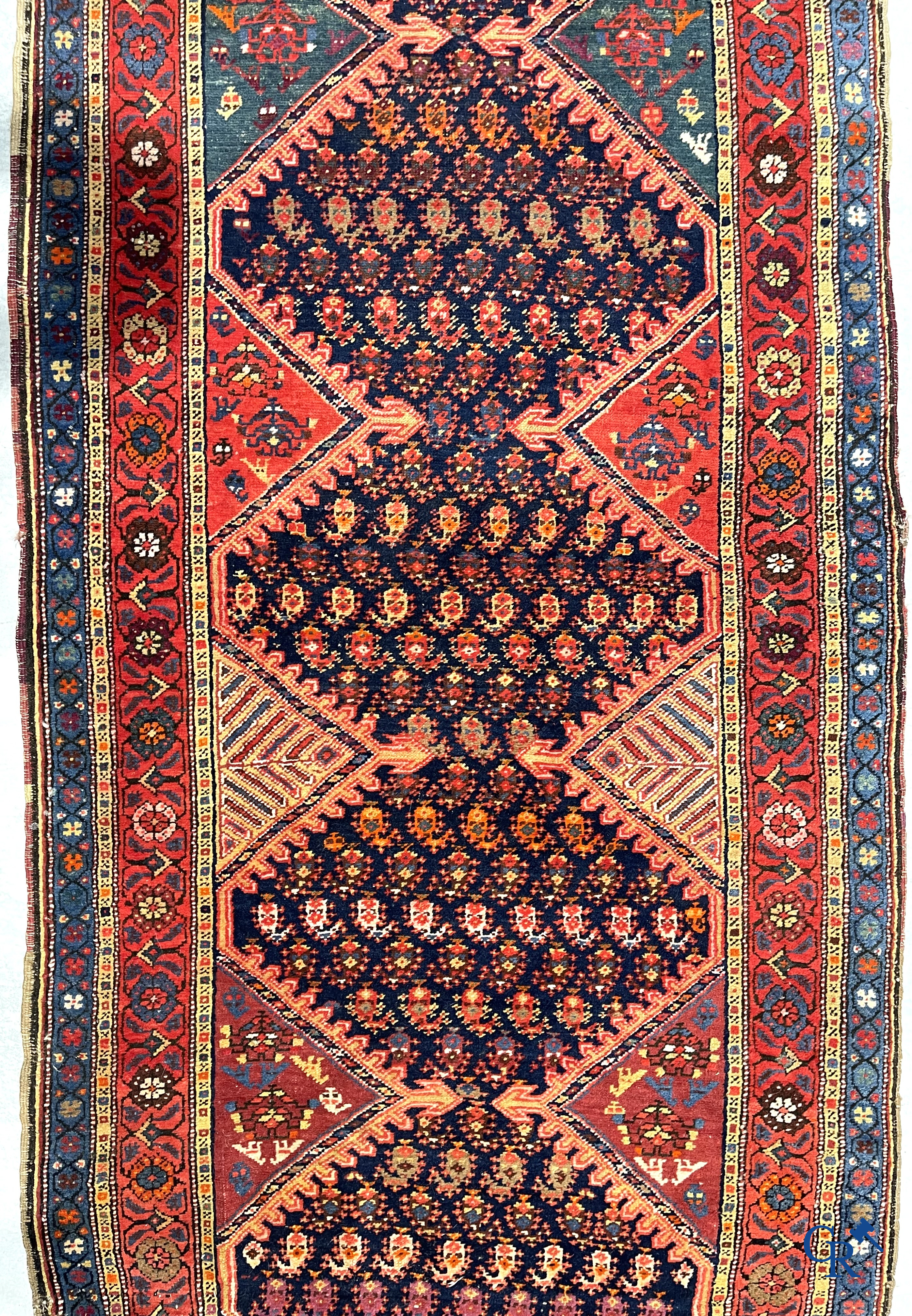 Oriental carpets. A large hand-knotted antique runner with geometric motifs. 19th century.