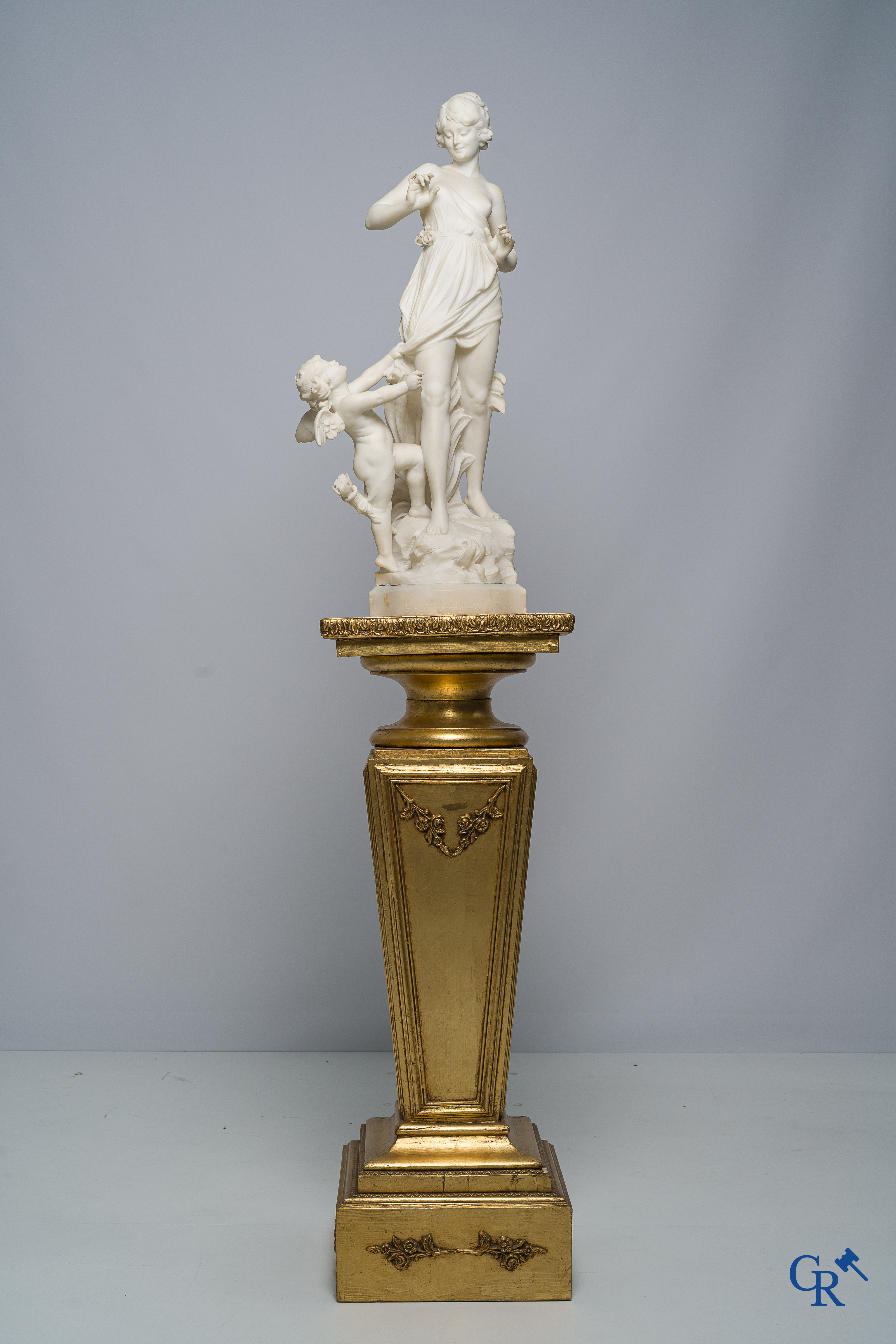 Cipriani. Romantic representation in sculpted marble. Young lady with cupid. LXVI style pedestal. Circa 1900.