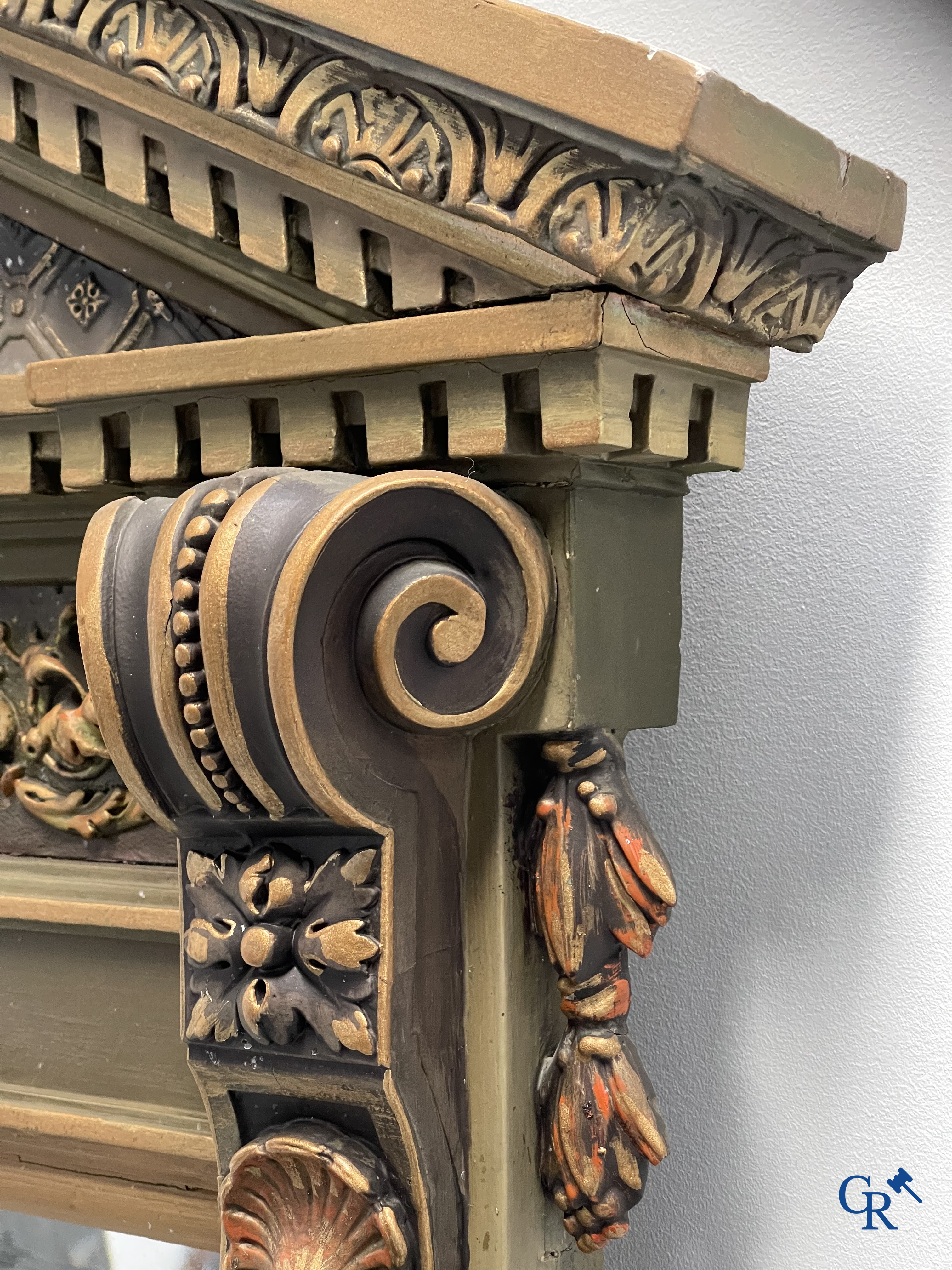 A large patinated fireplace mirror with a dragon. Around 1900.