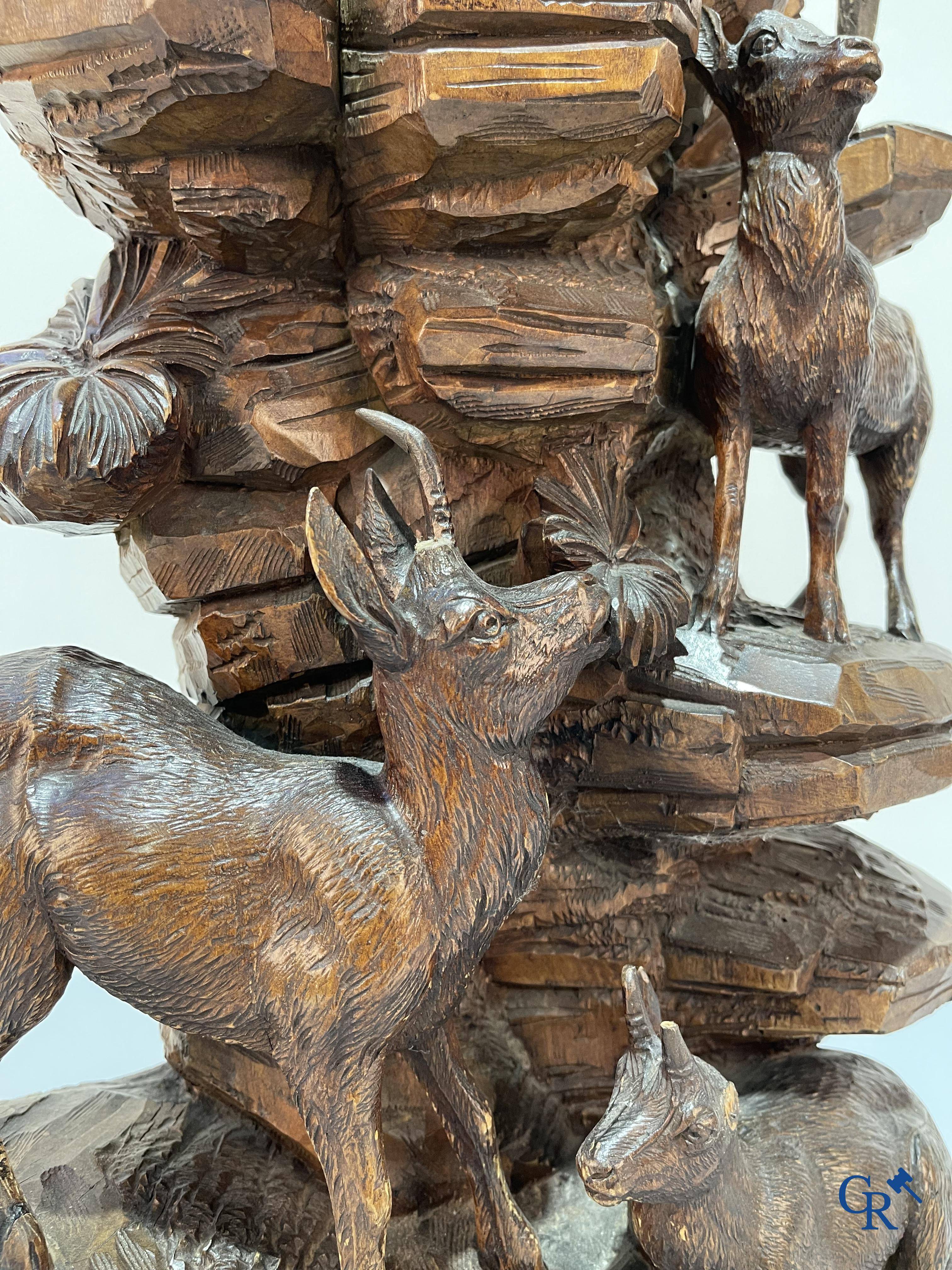 Imposing wood sculpture with chamois on a rocky mountain landscape in so-called "black forest". German work, late 19th century.
