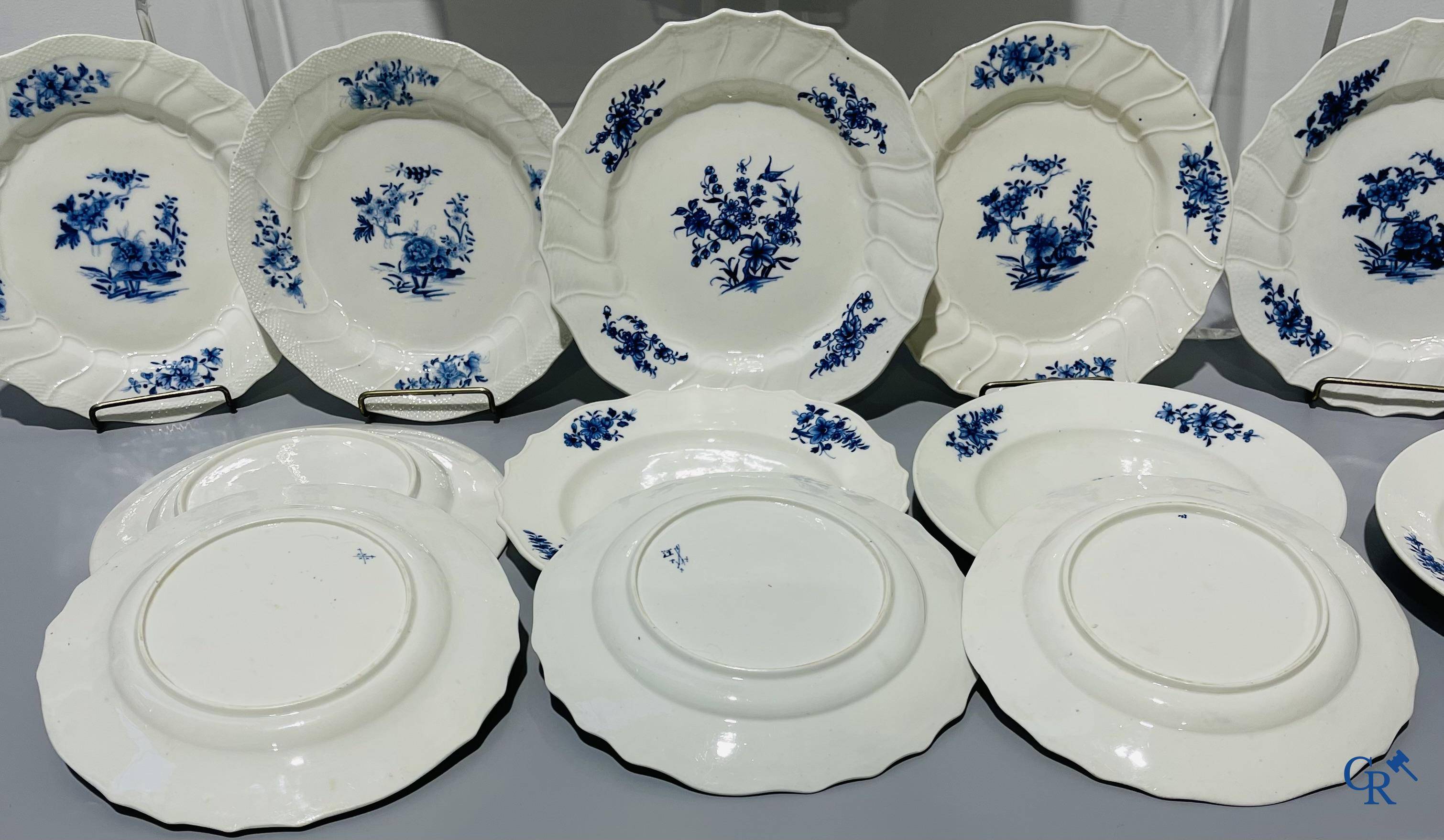 European porcelain, Tournai. 13 plates with blue decor and a large monochrome dish. 18th century.