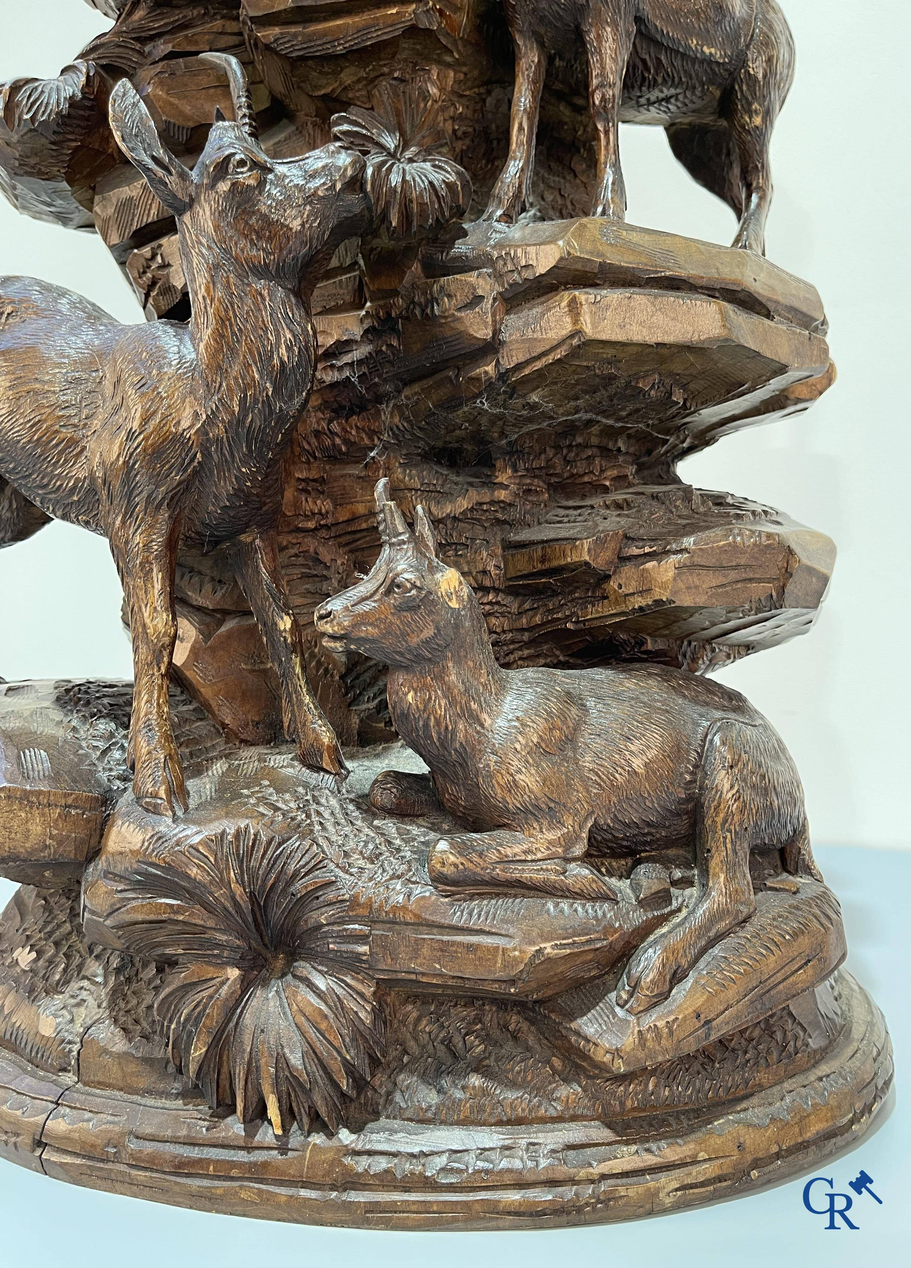Imposing wood sculpture with chamois on a rocky mountain landscape in so-called "black forest". German work, late 19th century.