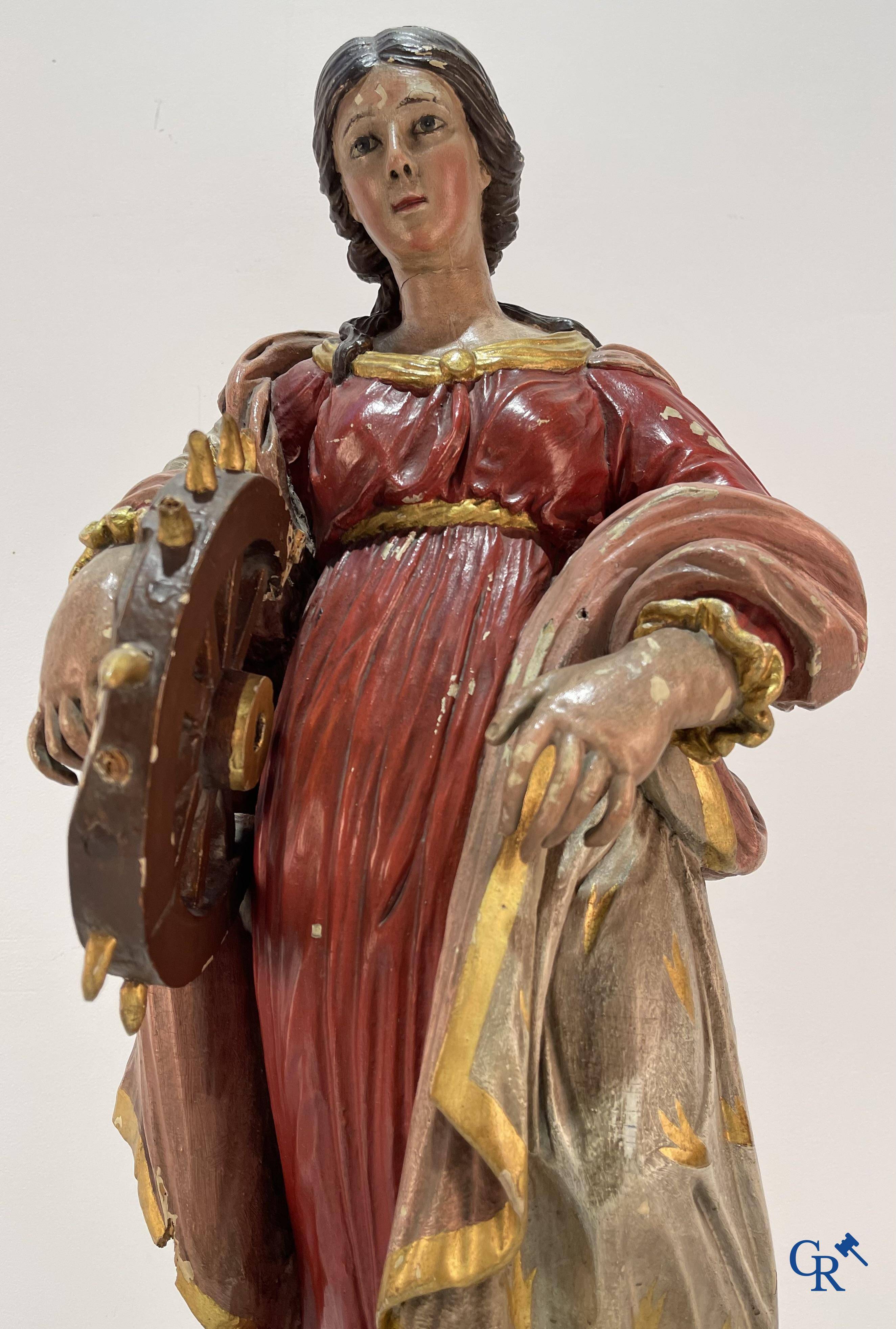 Religious objects, a finely carved and polychrome wooden statue of Saint Catherine in Baroque style. 18th century.