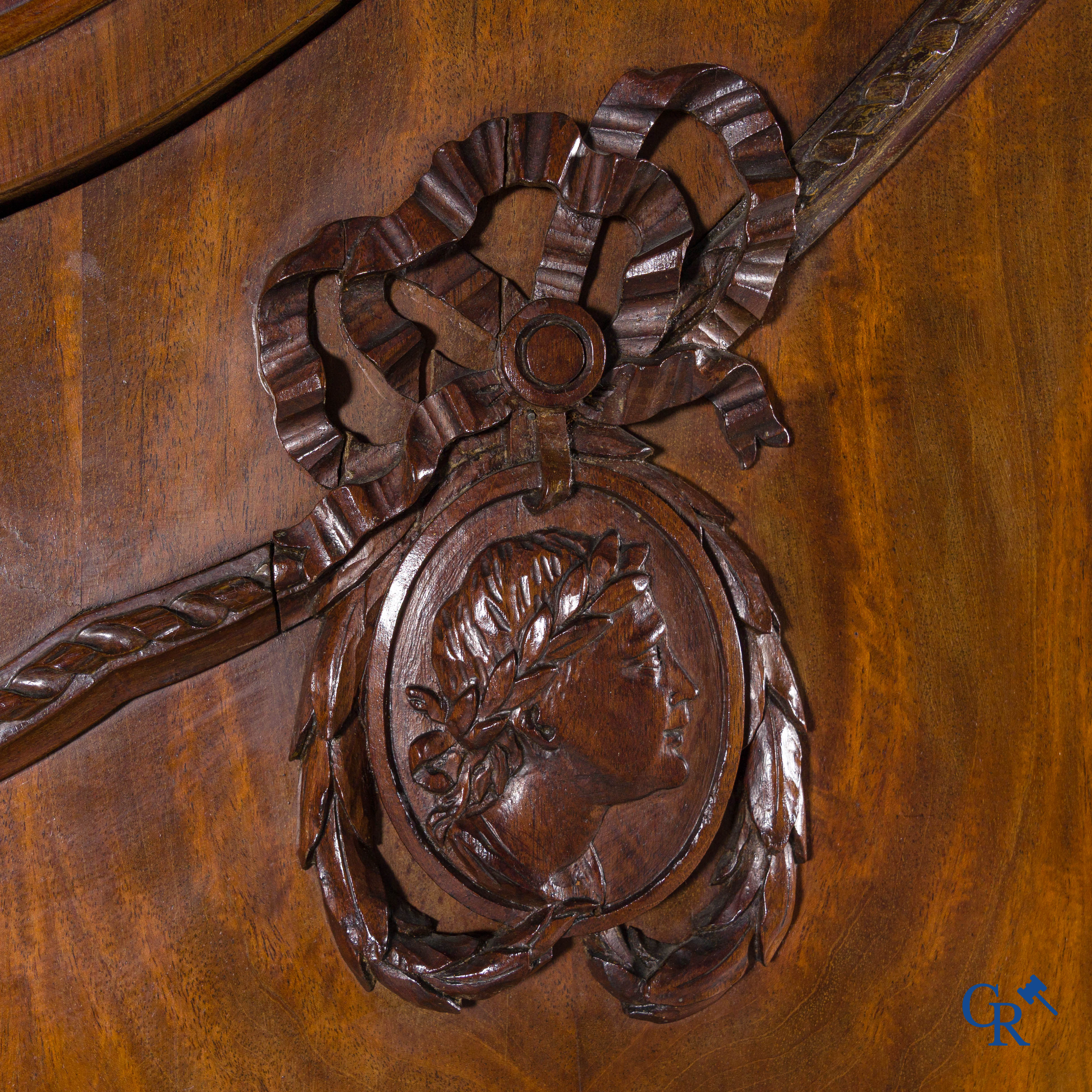 A large mahogany wooden cabinet with 3 drawers and 2 doors decorated with lockets. LXVI style.