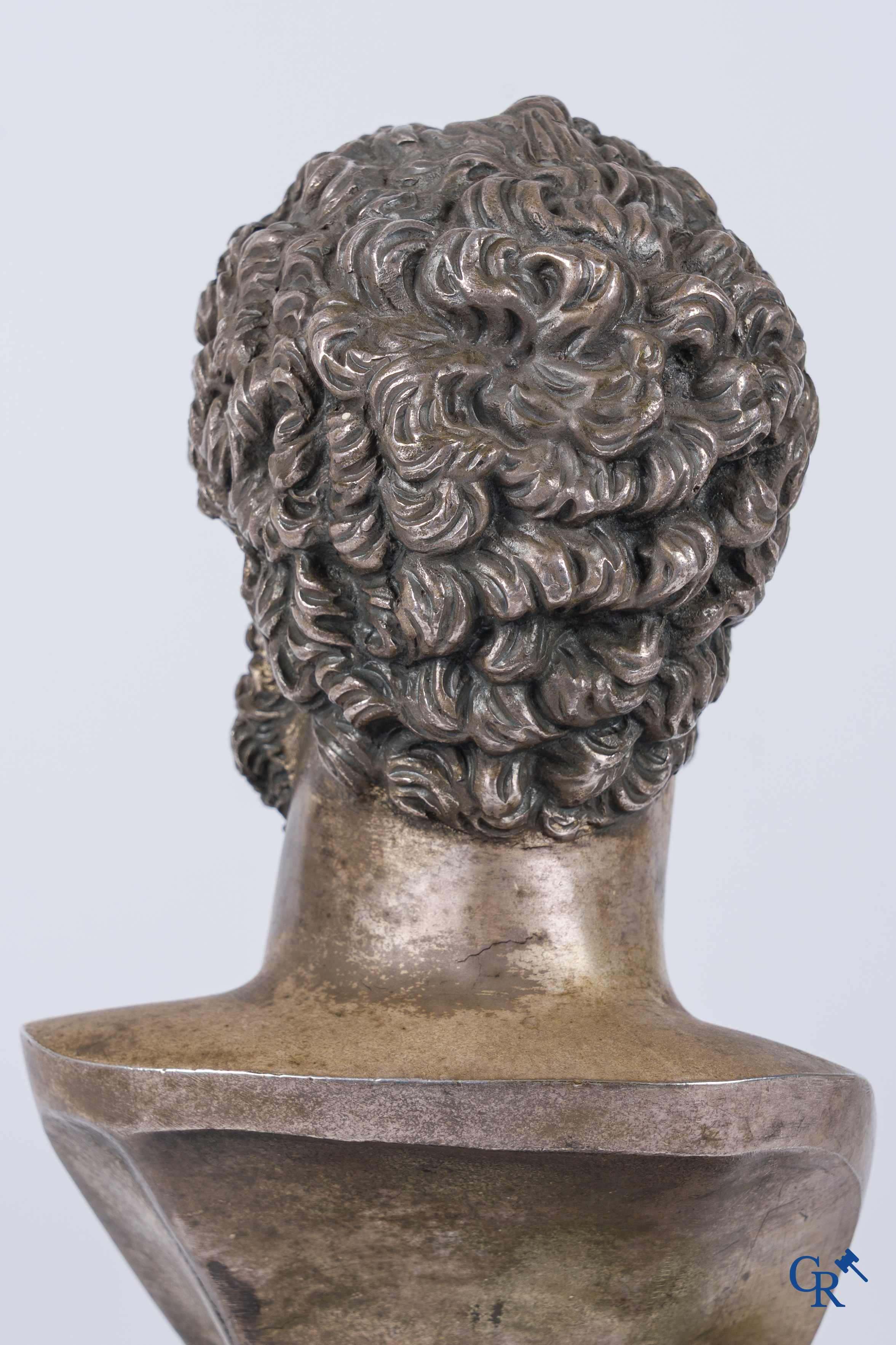 A silvered bronze bust of Lucius Verus on a dark green serpentine pedestal. 19th century.