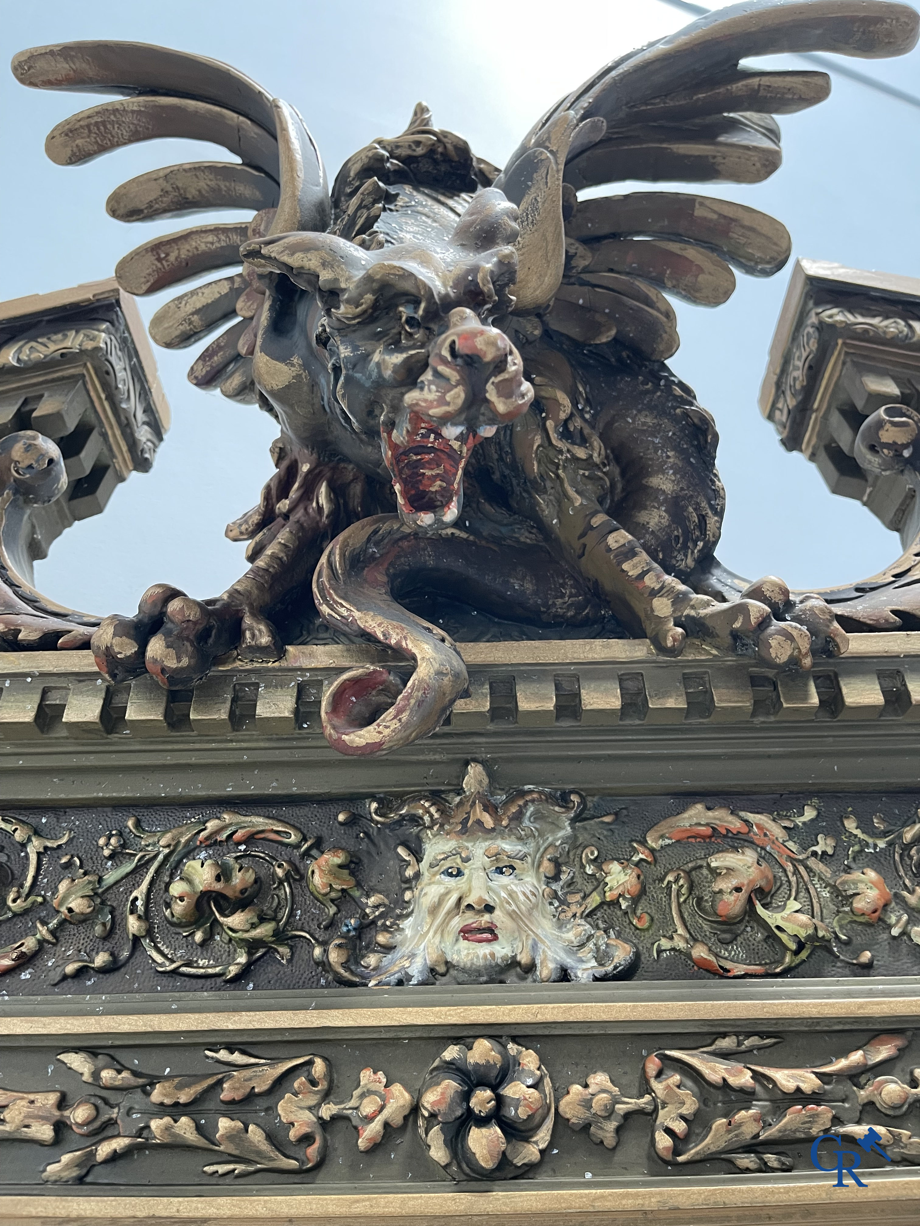 A large patinated fireplace mirror with a dragon. Around 1900.