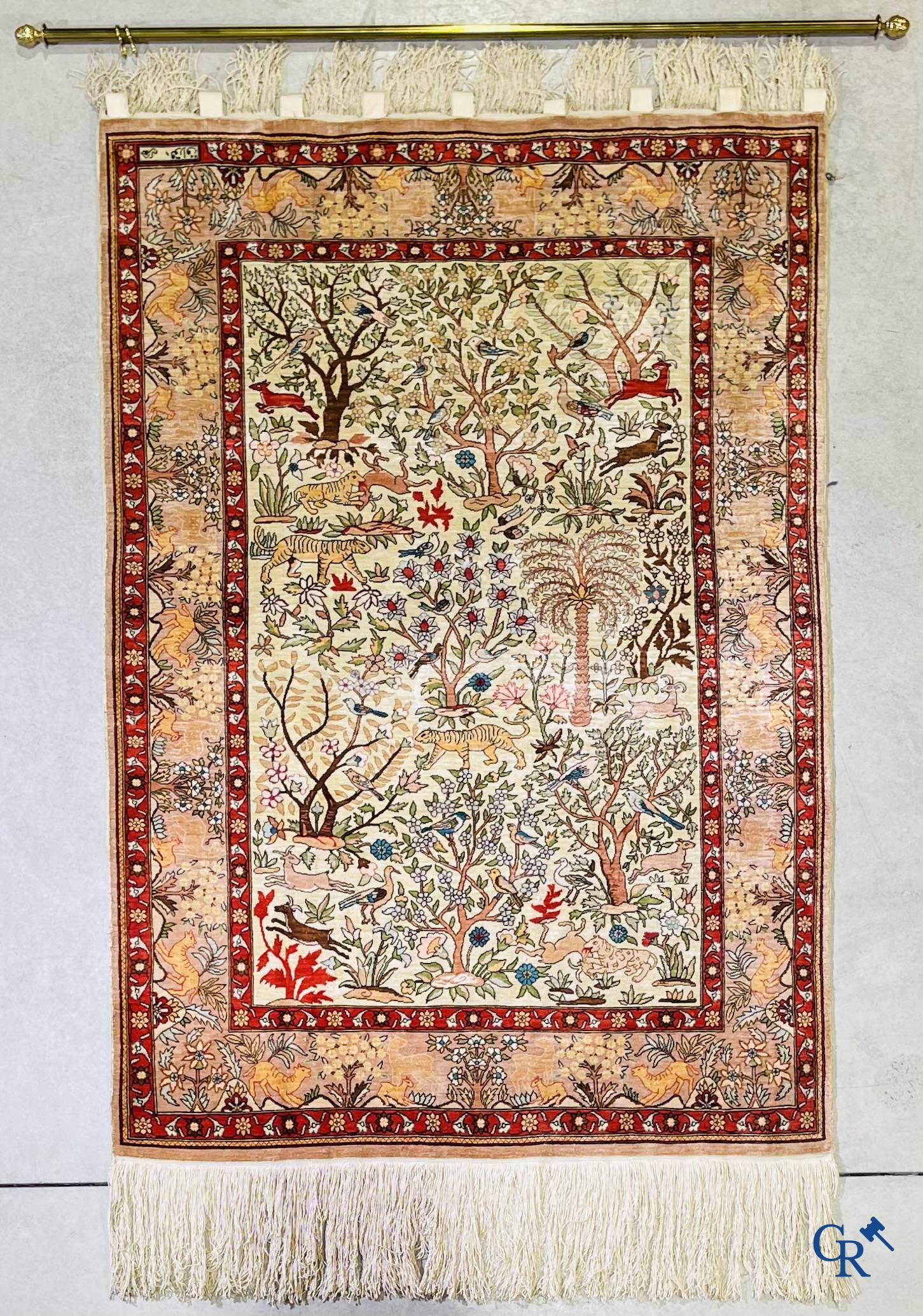 Oriental rugs, a fine hand-knotted silk tapestry with animals in a forest. Signed.