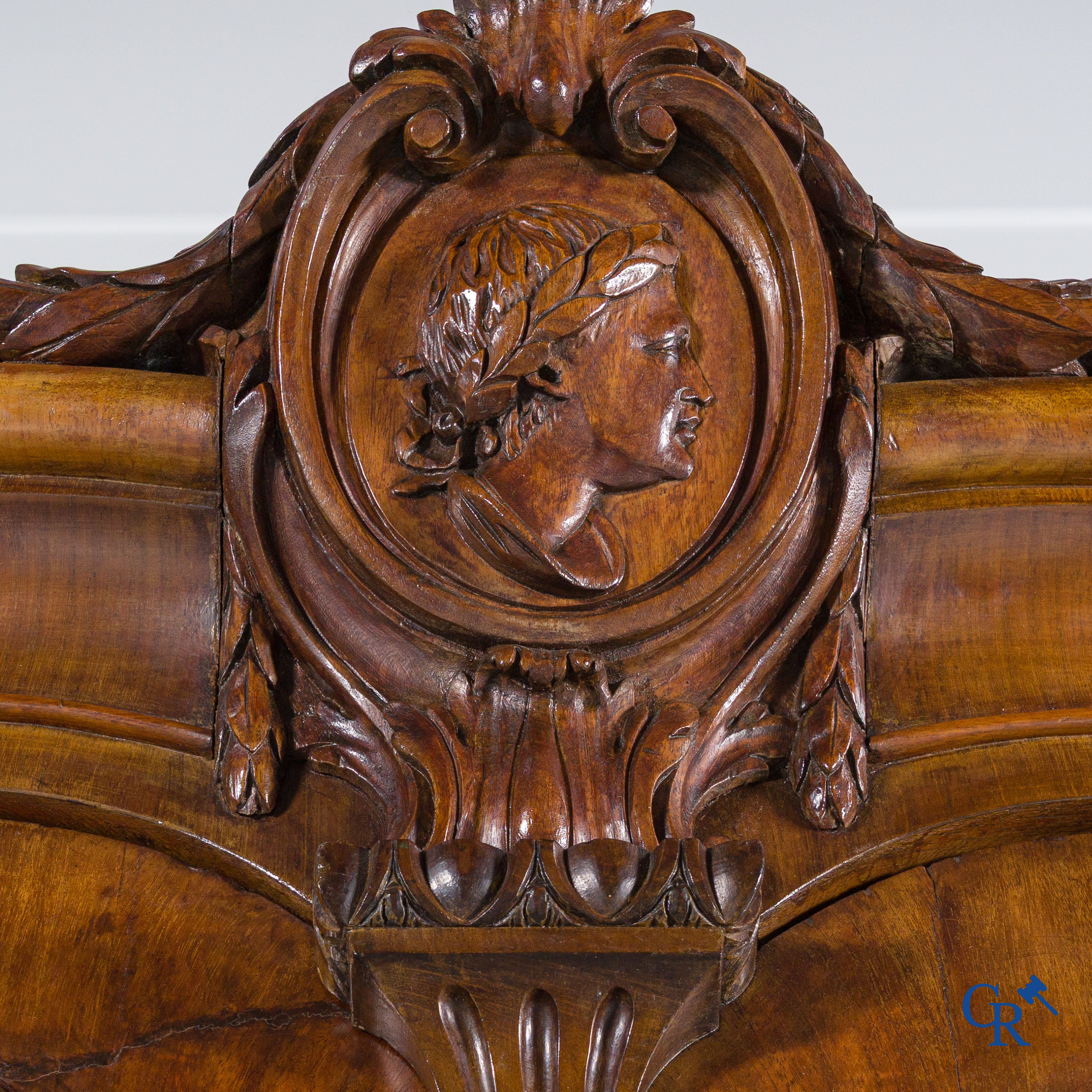 A large mahogany wooden cabinet with 3 drawers and 2 doors decorated with lockets. LXVI style.