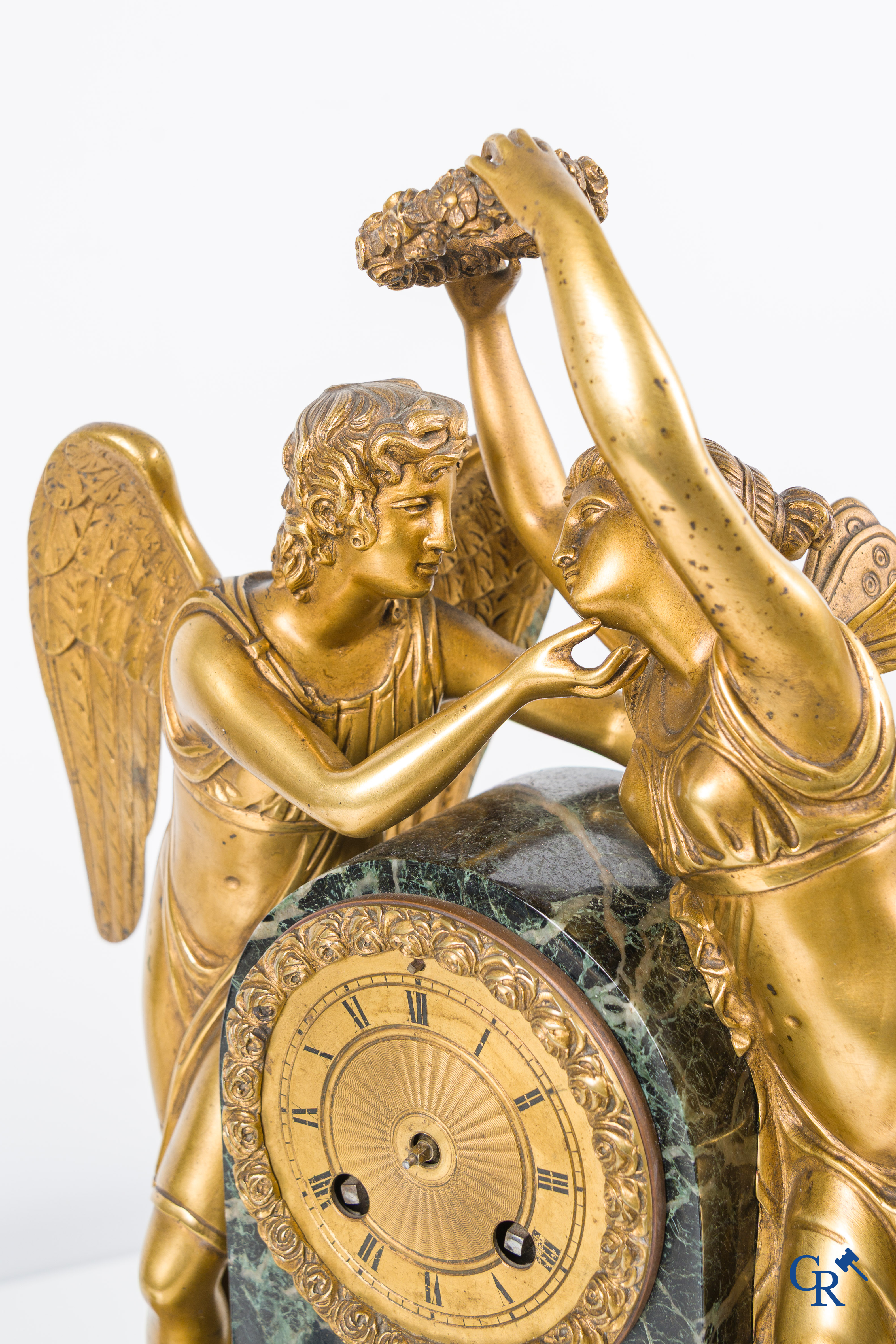 Een 3-delige schouwgarnituur in groen geaderde marmer en vergulde brons. Empire stijl. Circa 1900.