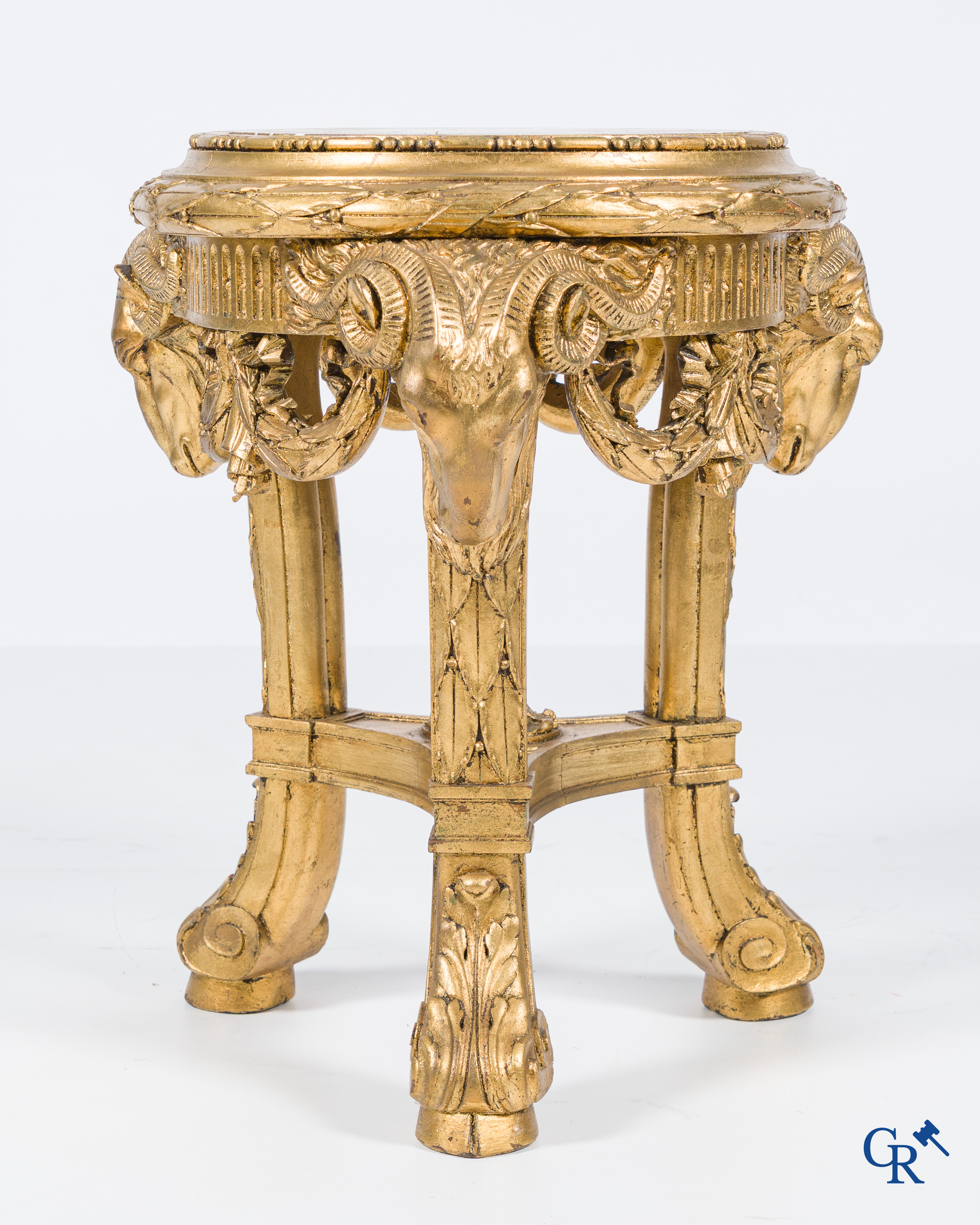 A large wood carved and gilded plinth with ram heads and garlands. LXVI style, circa 1900.