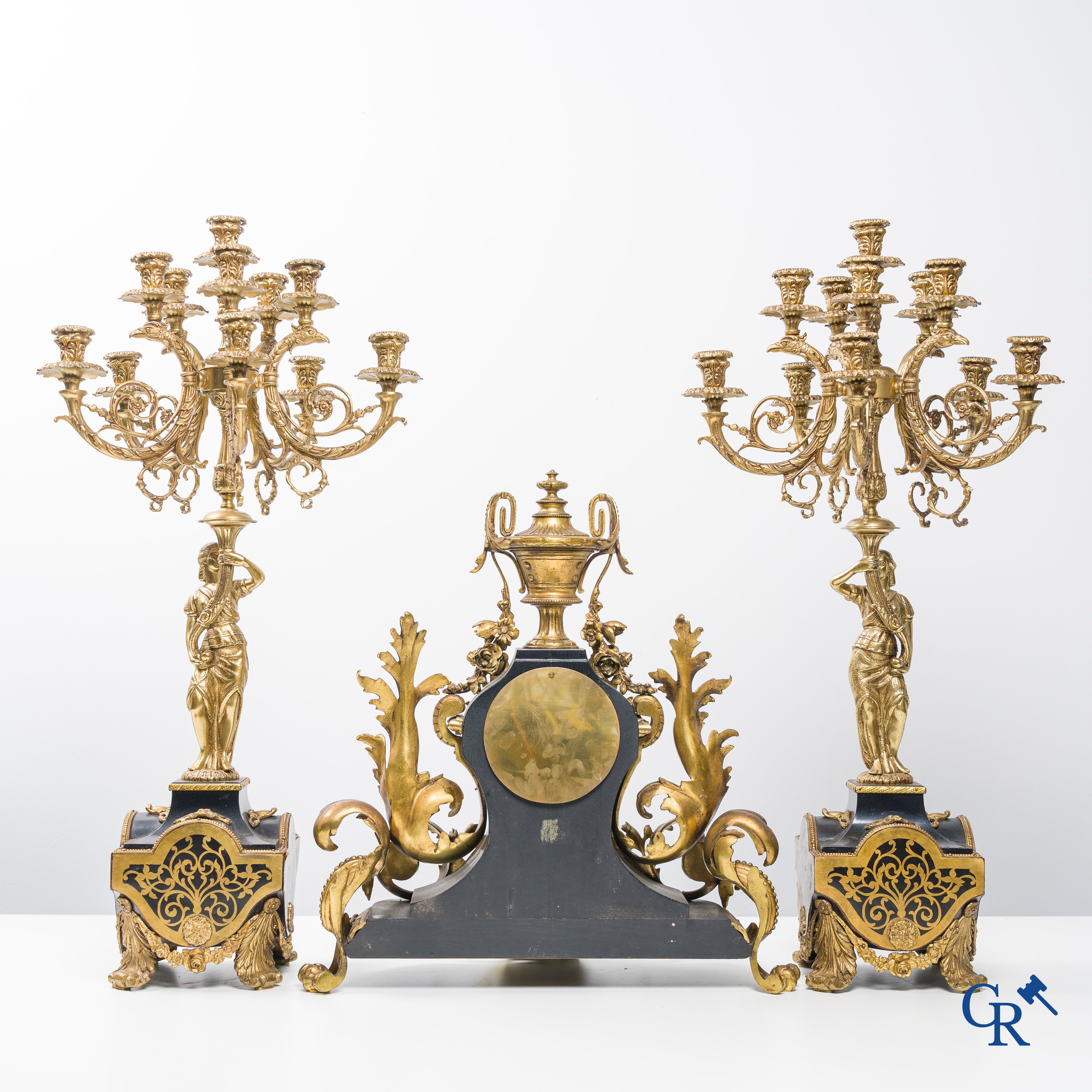 An imposing 3-piece chimney clock set in bronze and Boulle technique.