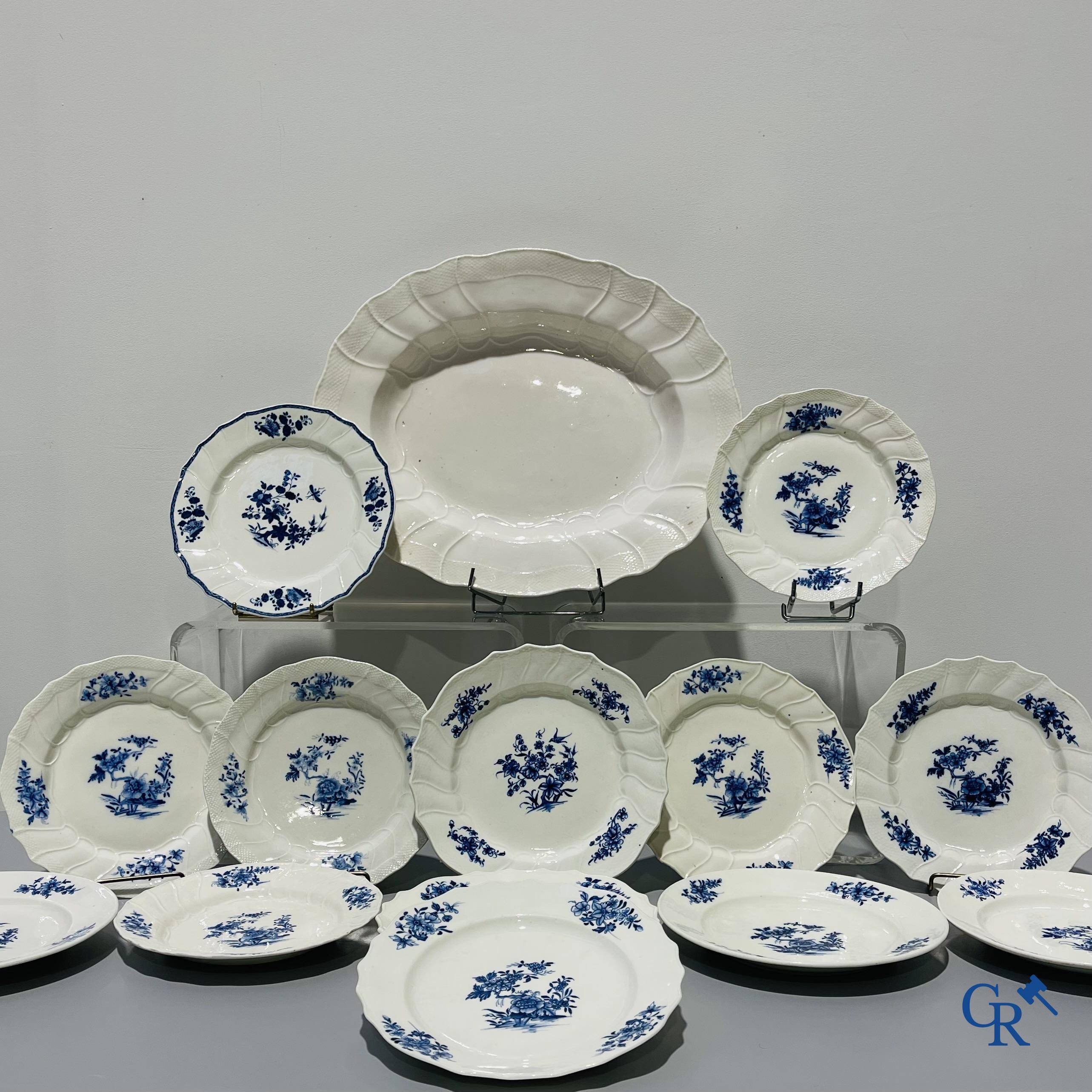 European porcelain, Tournai. 13 plates with blue decor and a large monochrome dish. 18th century.