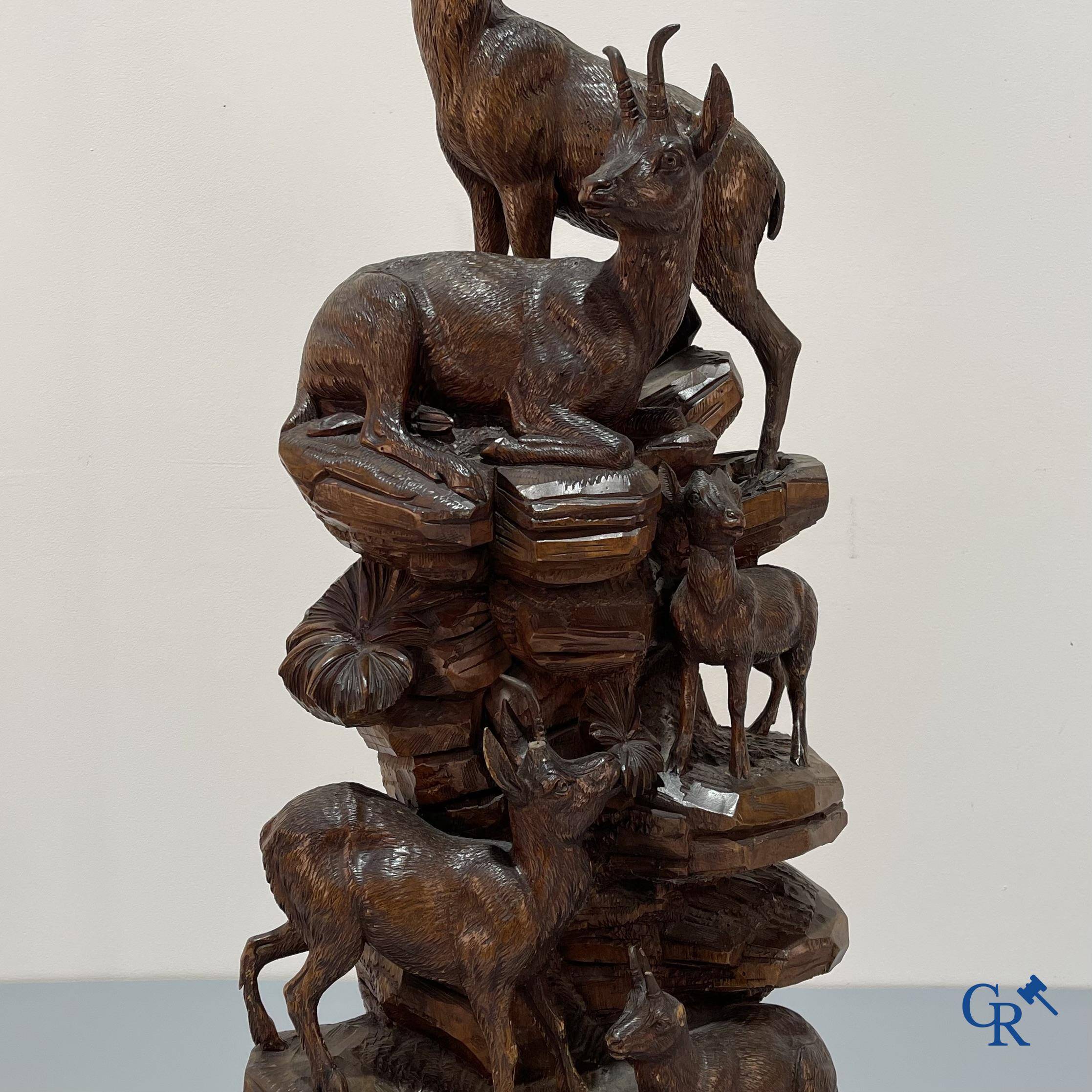 Imposing wood sculpture with chamois on a rocky mountain landscape in so-called "black forest". German work, late 19th century.