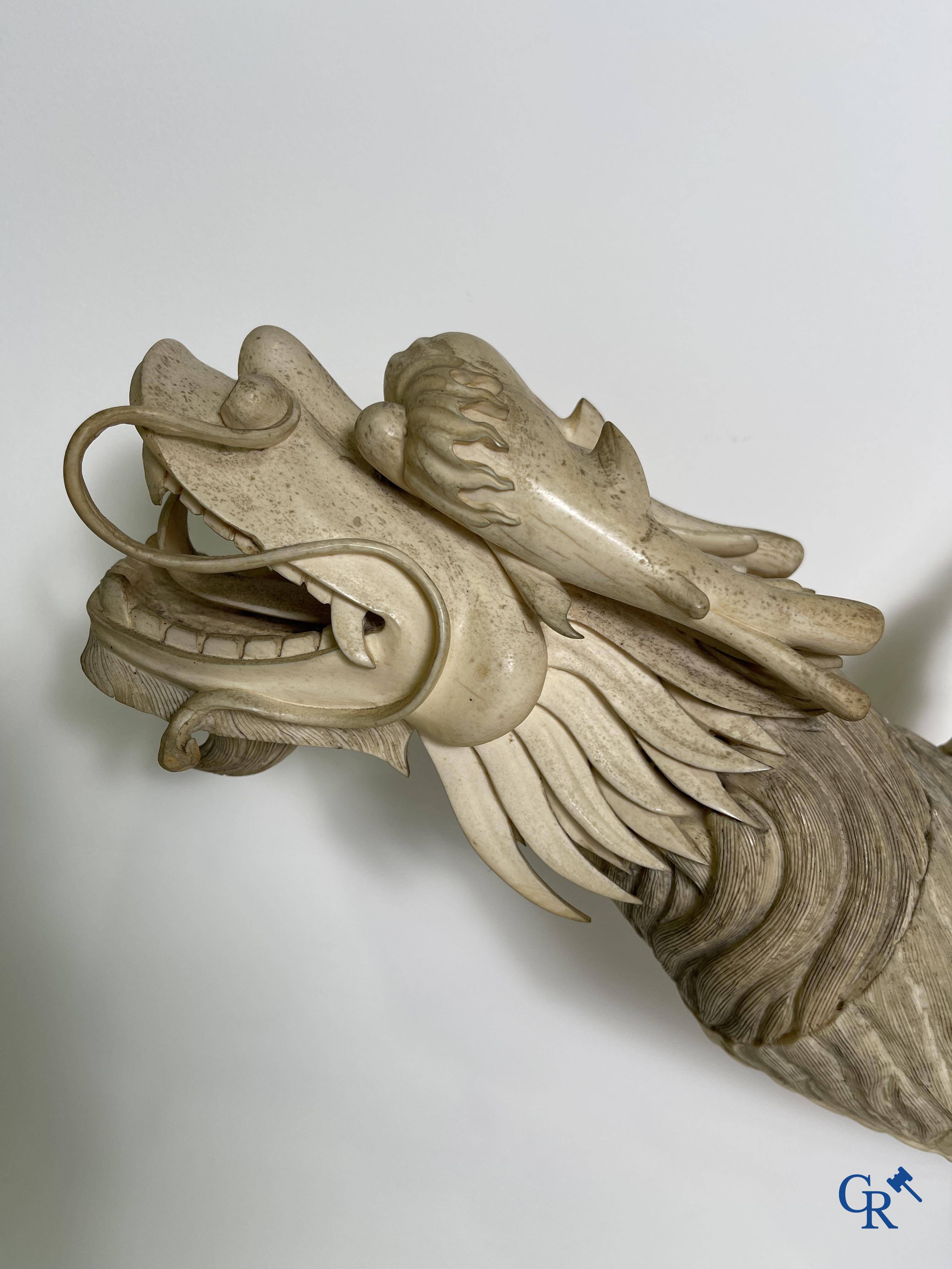 Asian Art: A large Chinese ivory dragon boat on a wooden pedestal. 19th century.