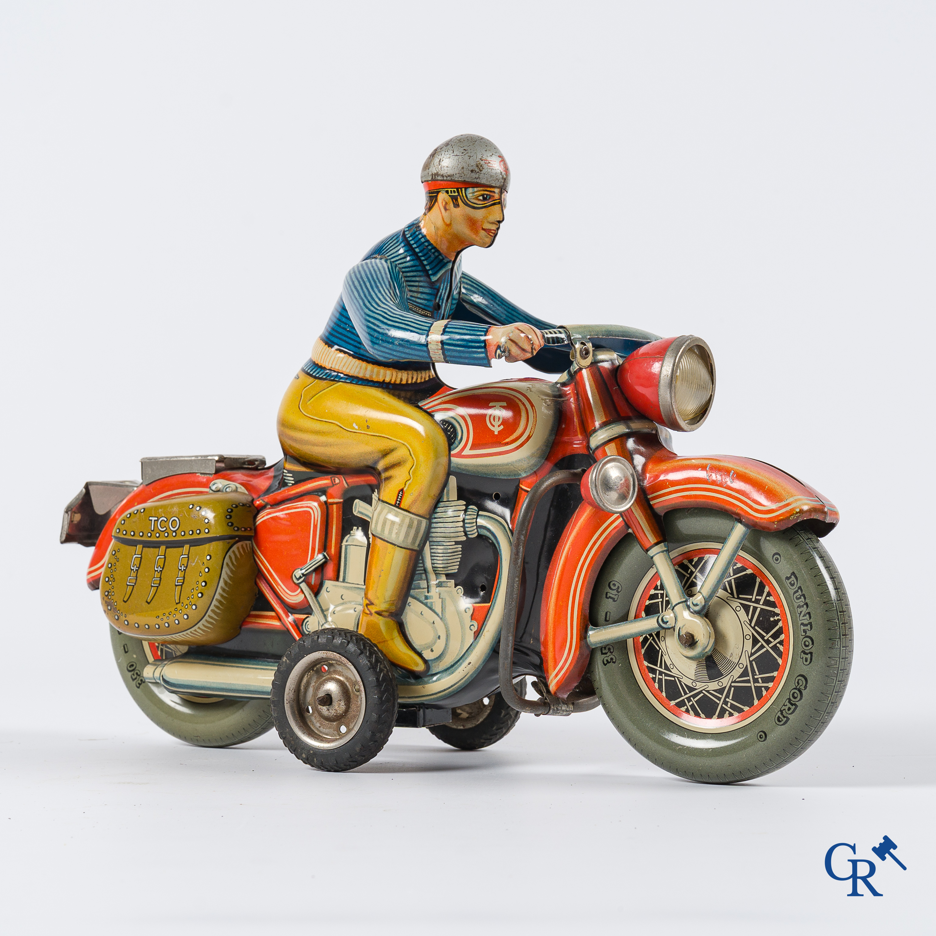 Oud speelgoed. Tipco, Western Germany. Motorfiets in beschilderd blik. Jaren '50.