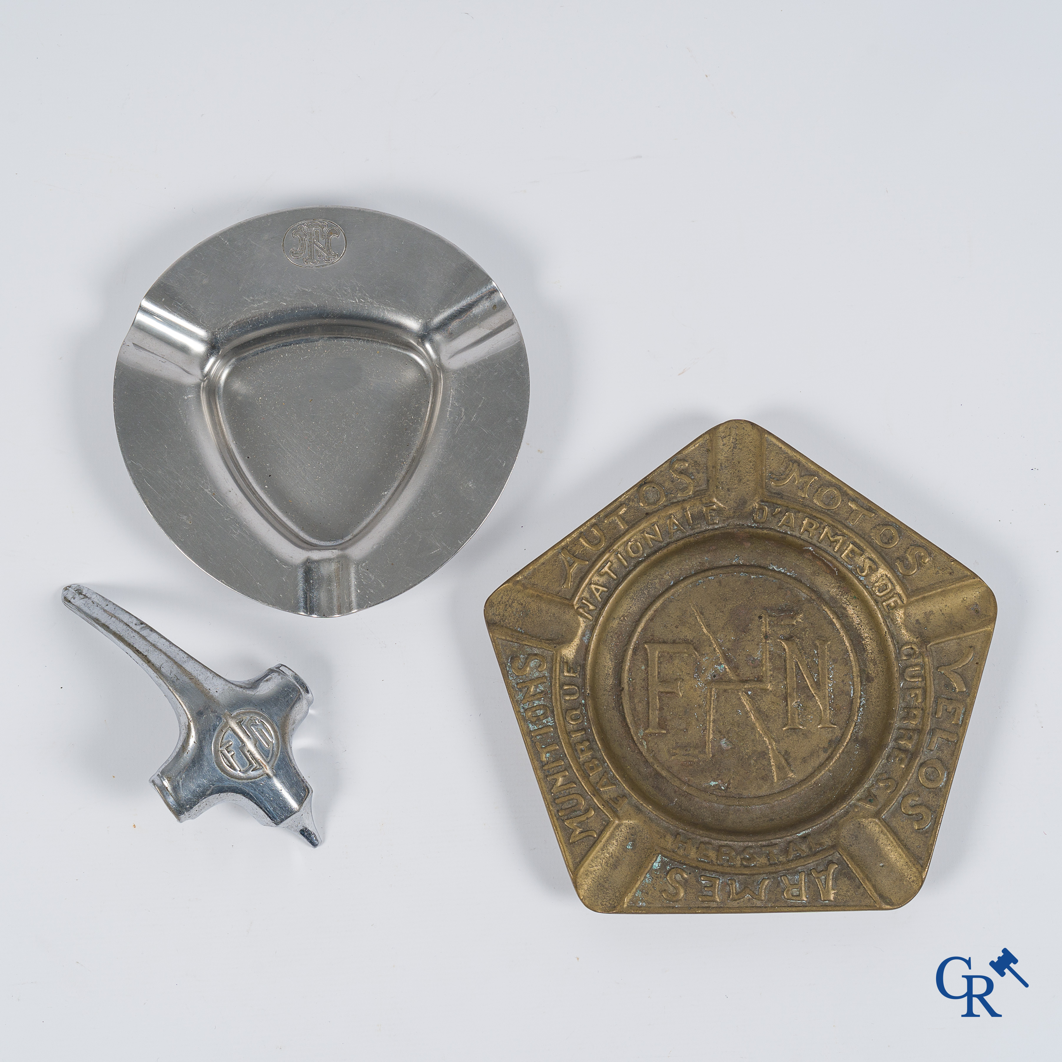 Fabrique Nationale Herstal. FN. An automobile mascot and 2 ashtrays with the FN logo.
