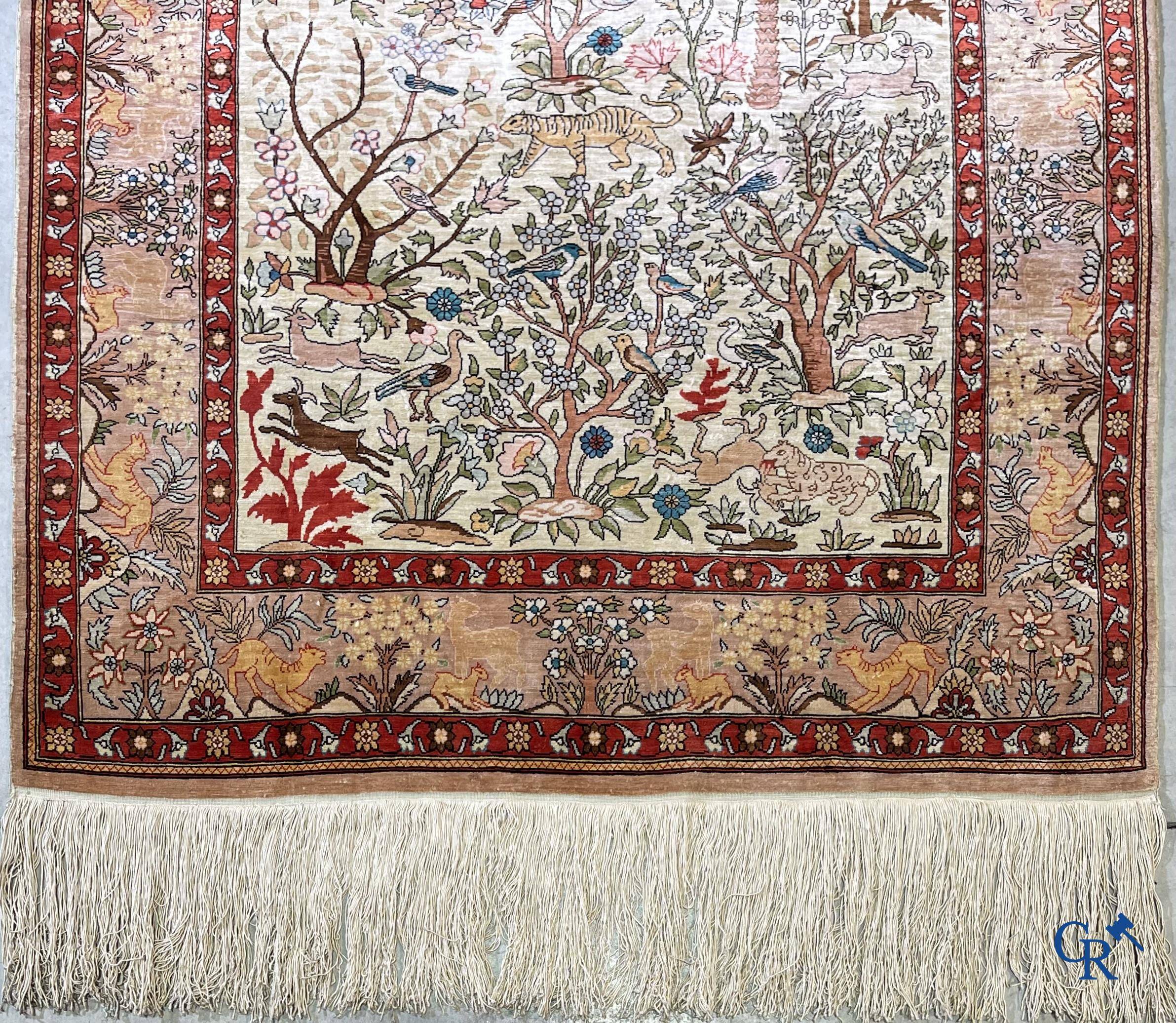 Oriental rugs, a fine hand-knotted silk tapestry with animals in a forest. Signed.