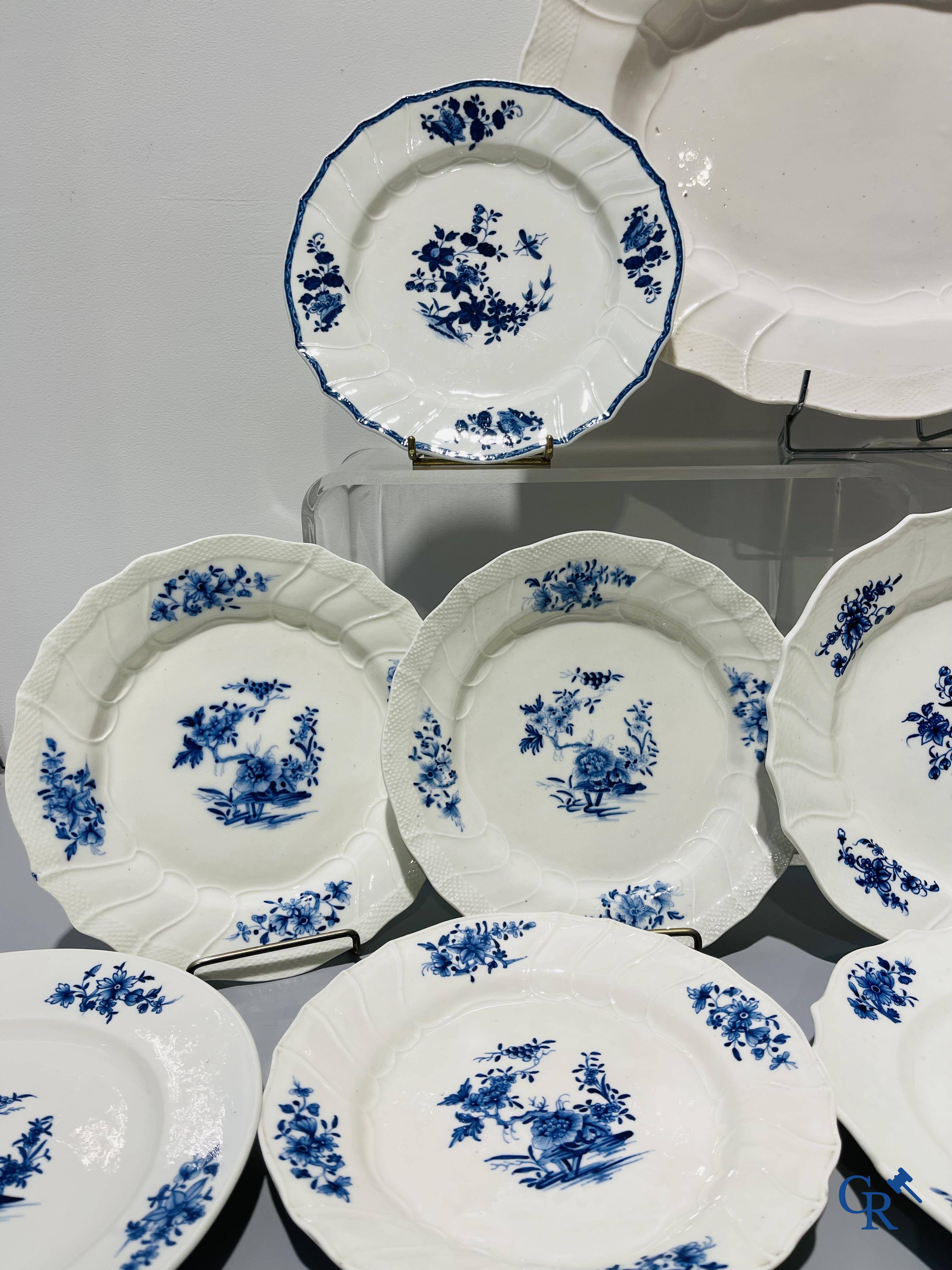 European porcelain, Tournai. 13 plates with blue decor and a large monochrome dish. 18th century.