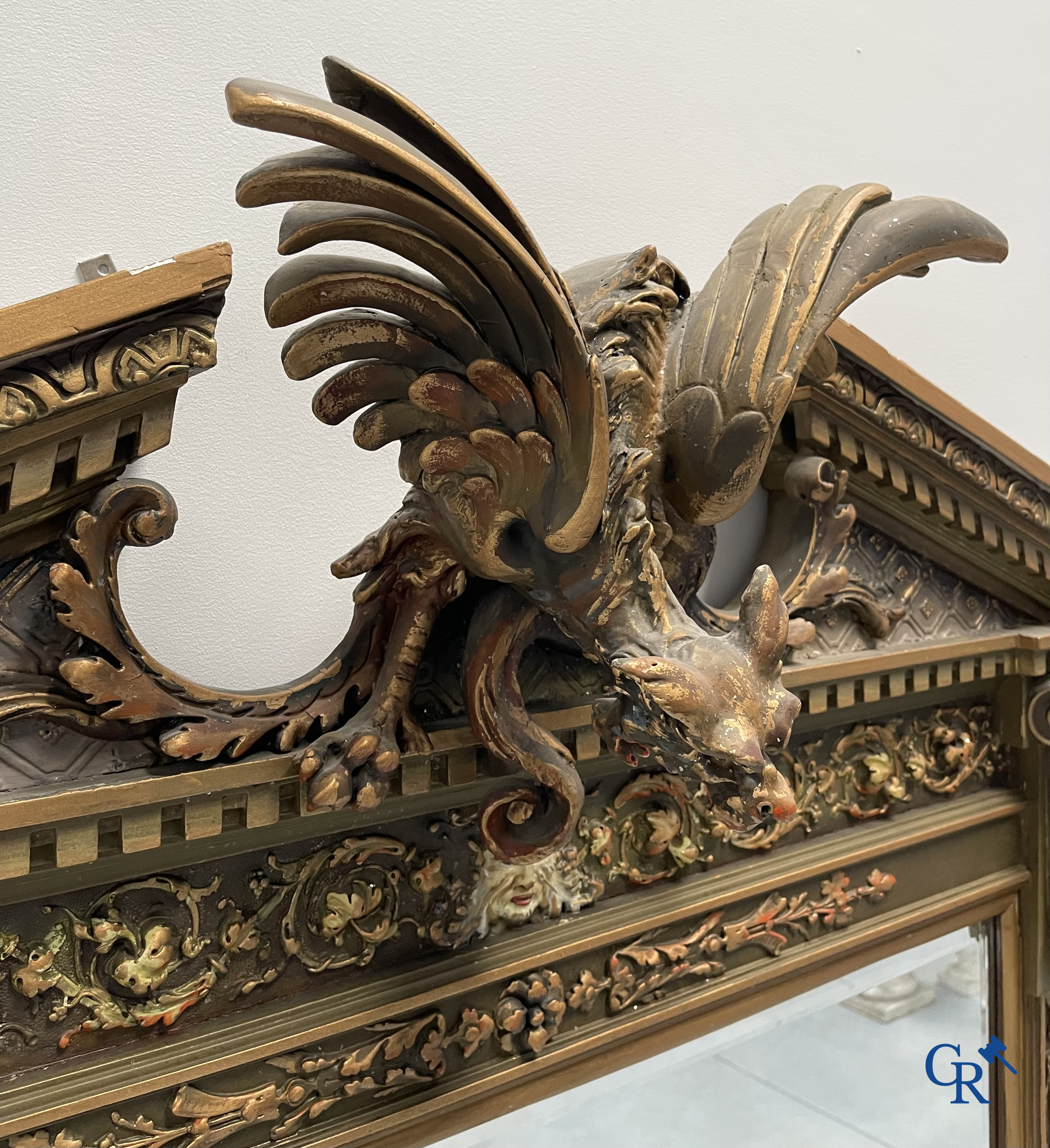 A large patinated fireplace mirror with a dragon. Around 1900.