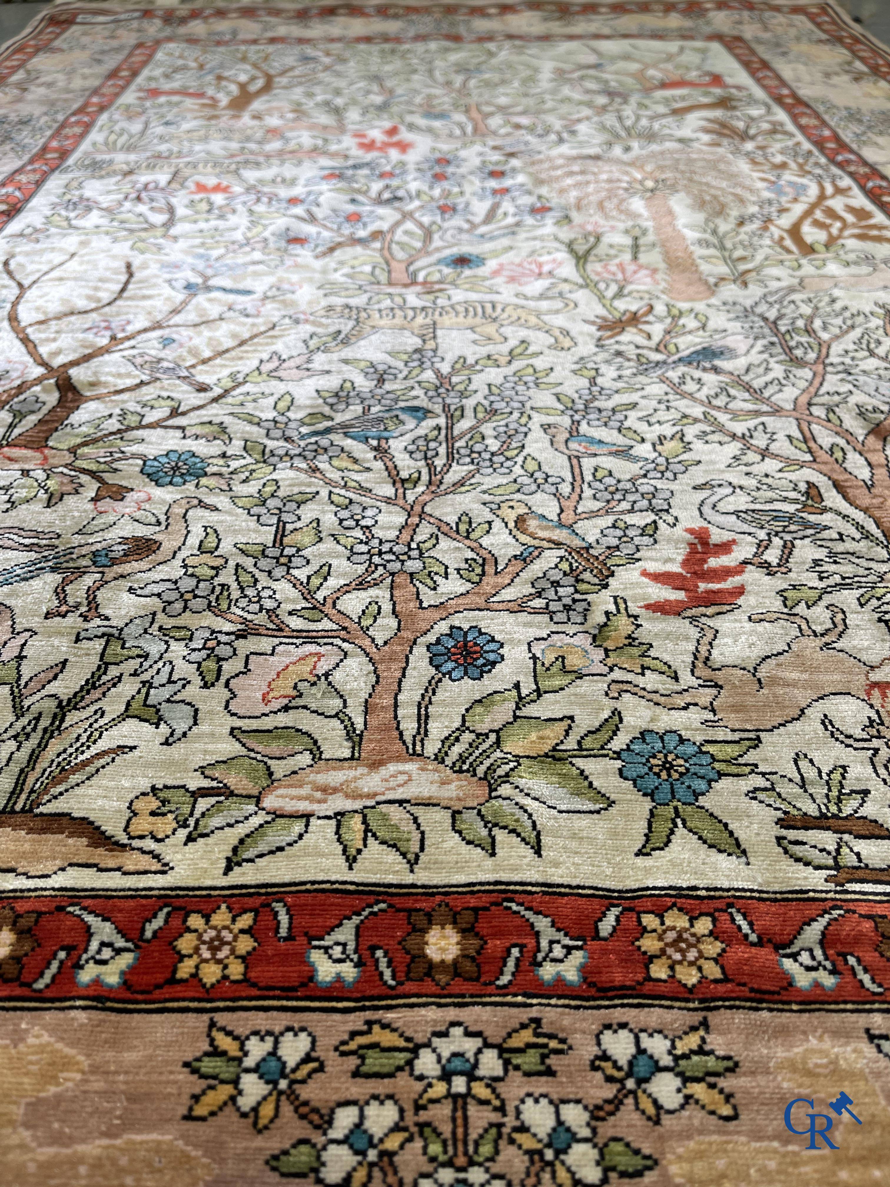 Oriental rugs, a fine hand-knotted silk tapestry with animals in a forest. Signed.