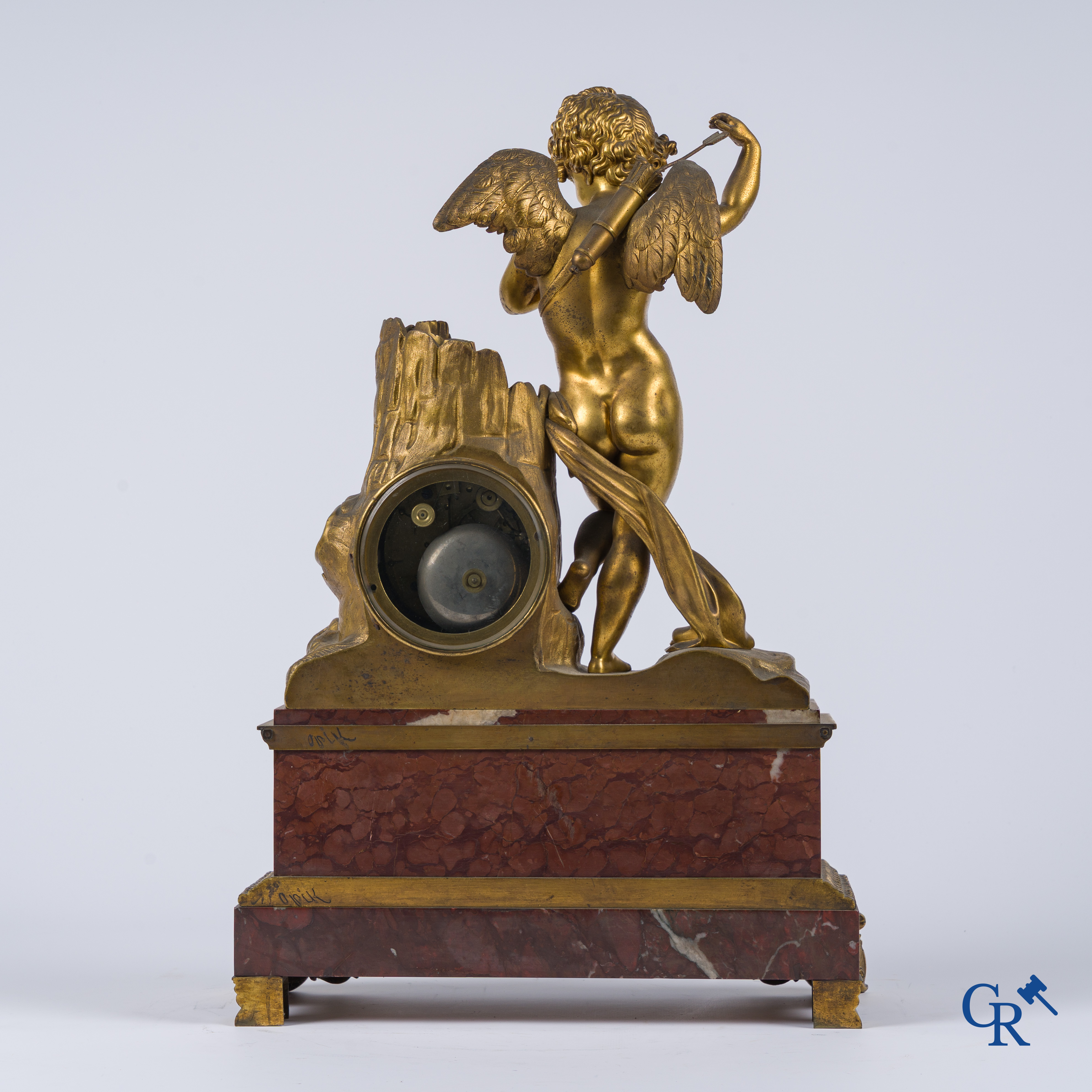 Charles X, a pendulum with finely chiseled cupid in gilded bronze. Red veined marble pedestal, circa 1840.