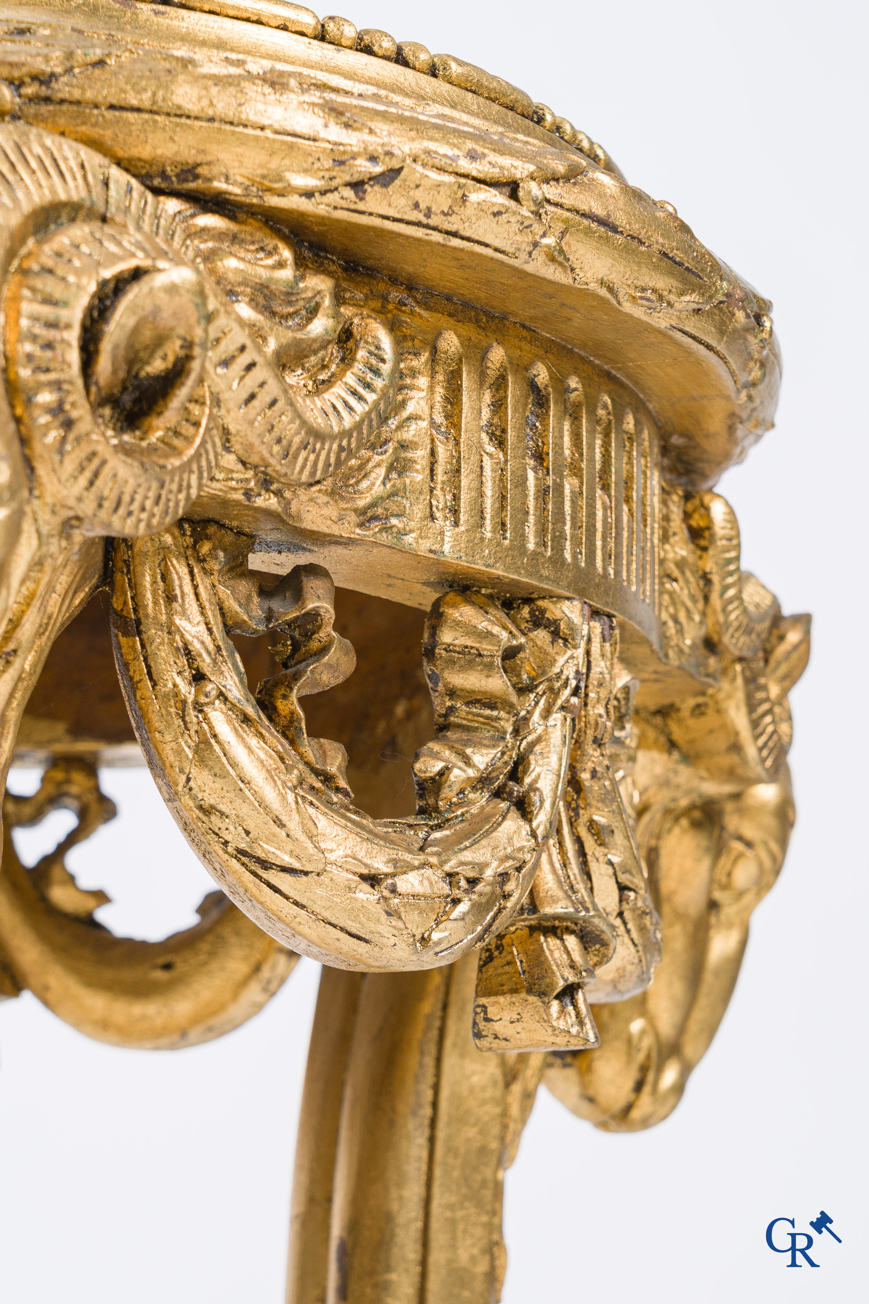 A large wood carved and gilded plinth with ram heads and garlands. LXVI style, circa 1900.