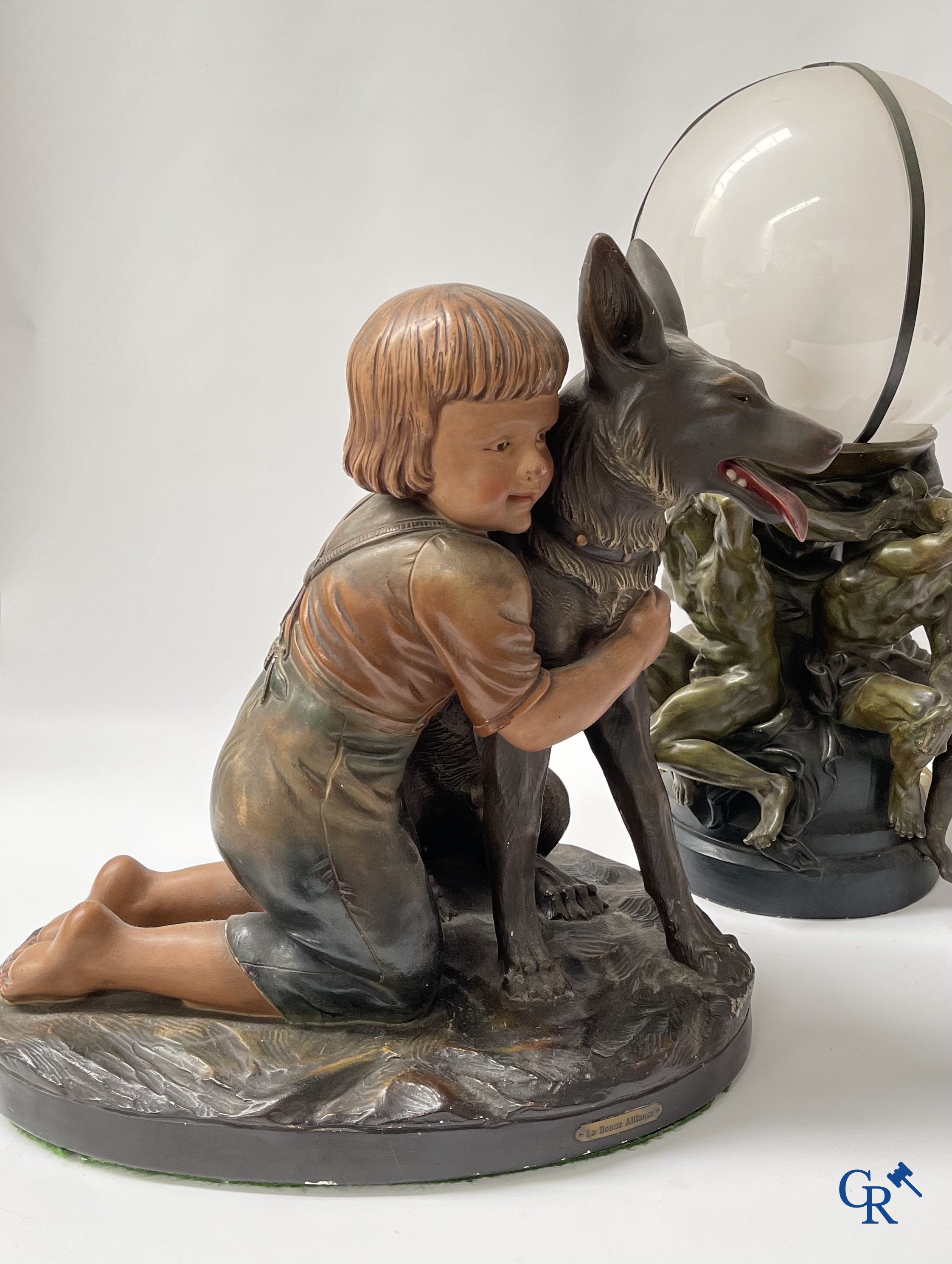 Plaster sculpture, boy with dog and a plaster lamp.