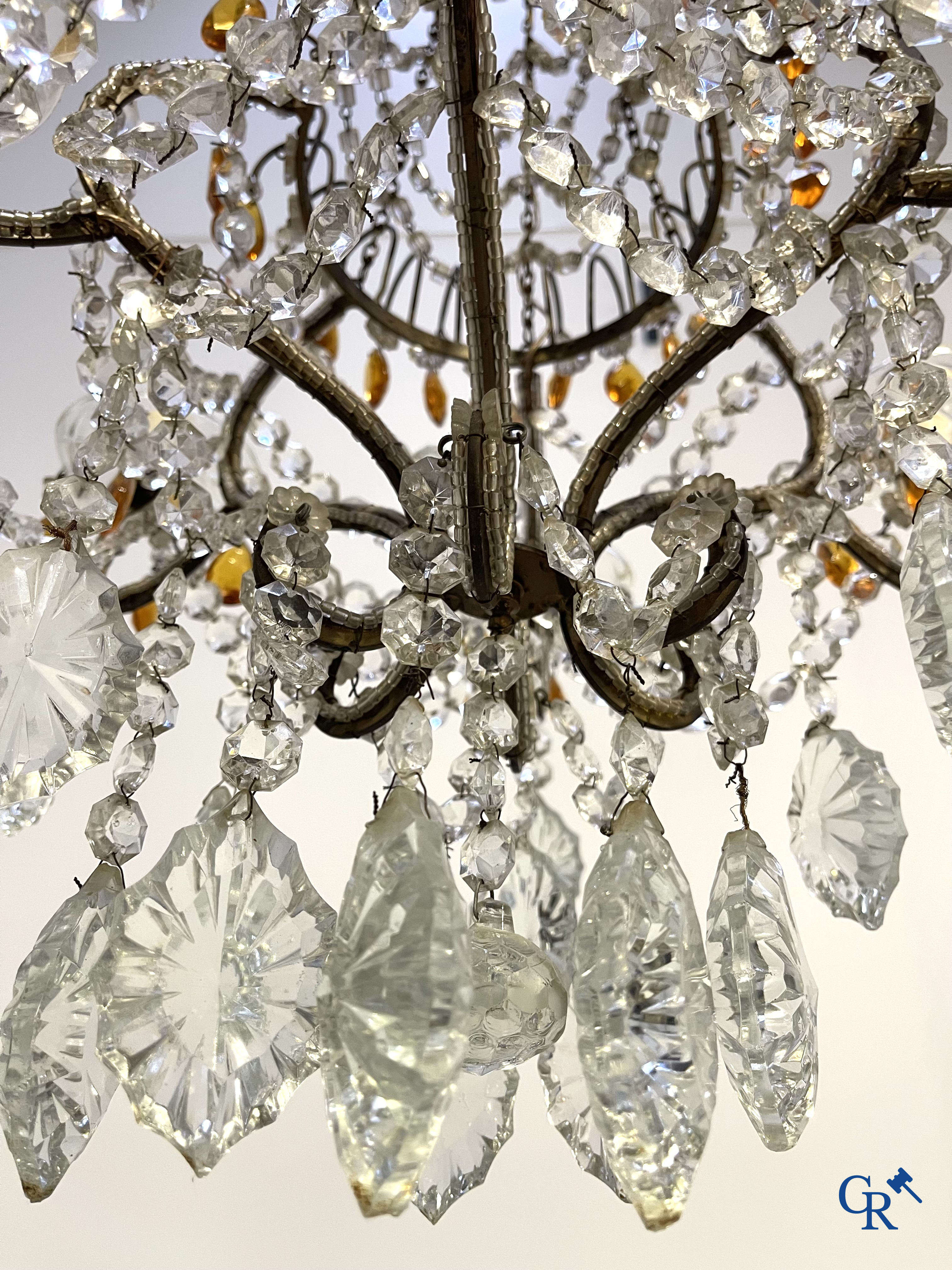 A large chandelier in crystal with double pearls on the frame.