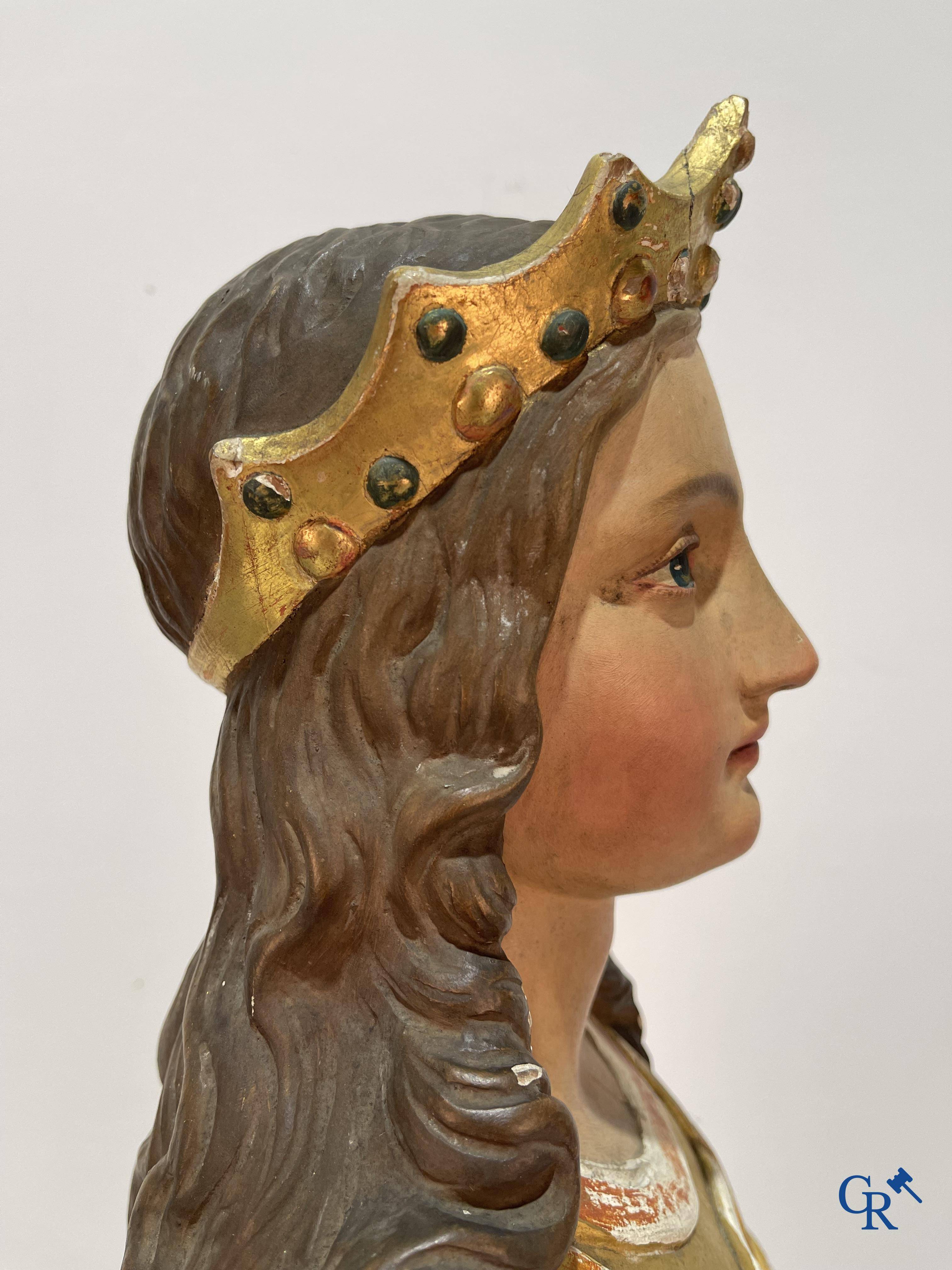 A large gilded and polychrome wooden statue of Saint Catherine of Alexandria.