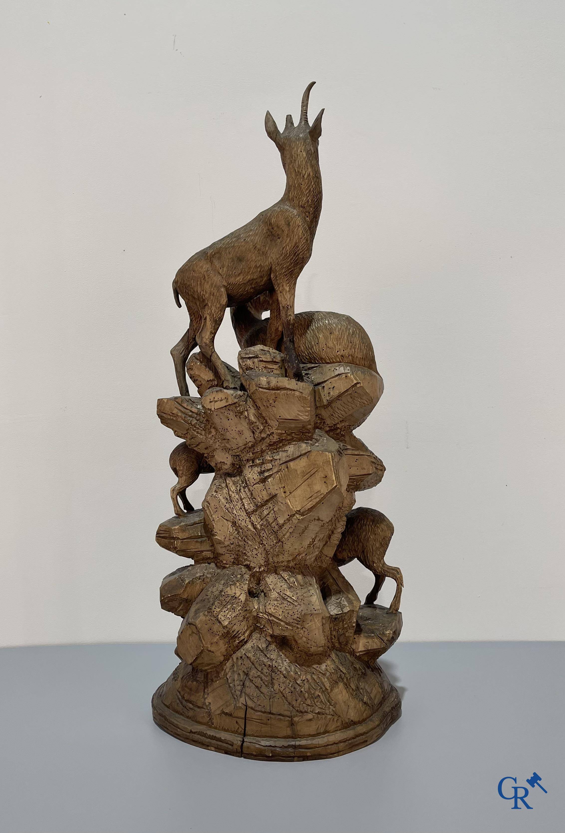 Imposing wood sculpture with chamois on a rocky mountain landscape in so-called "black forest". German work, late 19th century.