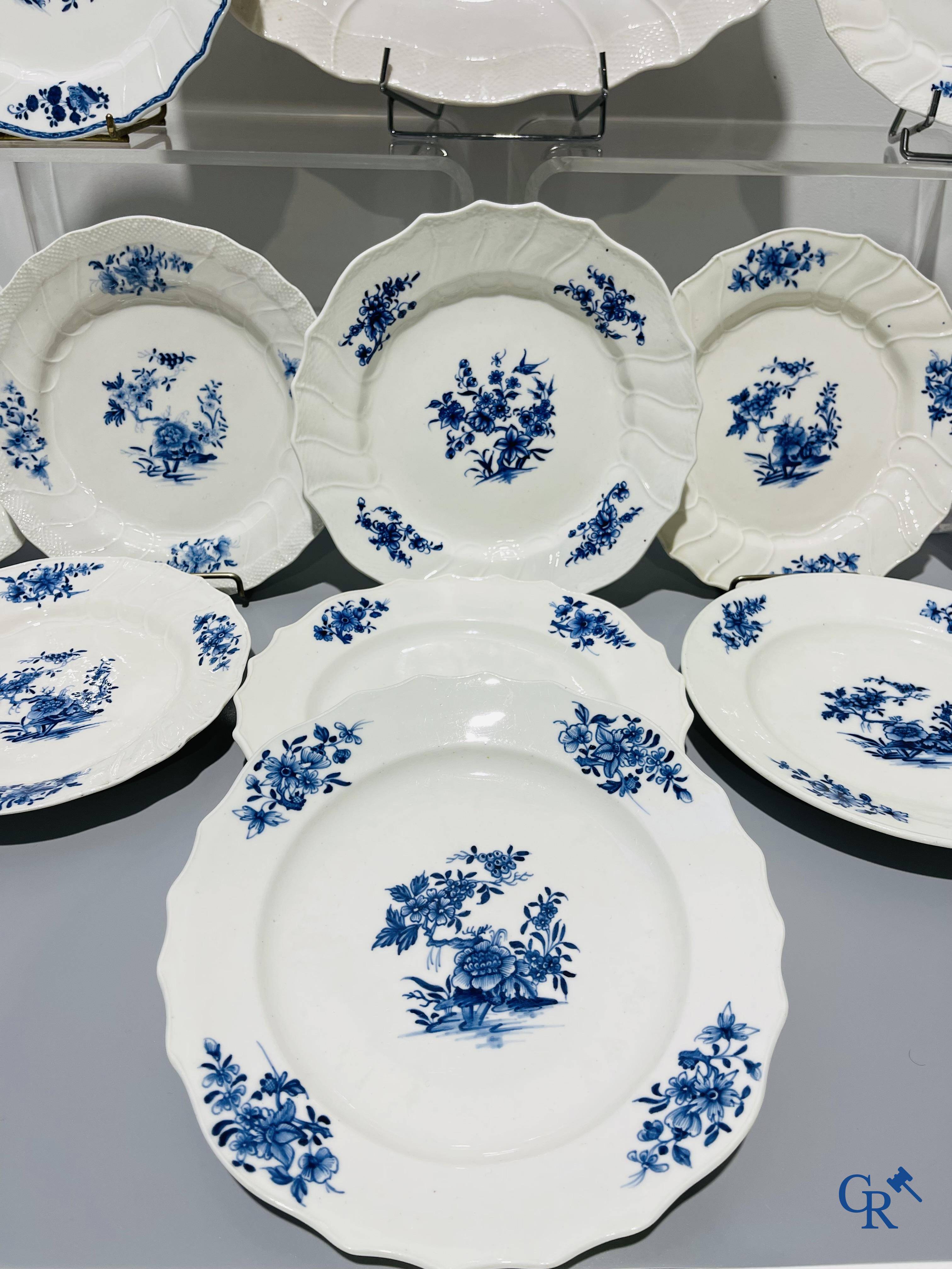 European porcelain, Tournai. 13 plates with blue decor and a large monochrome dish. 18th century.